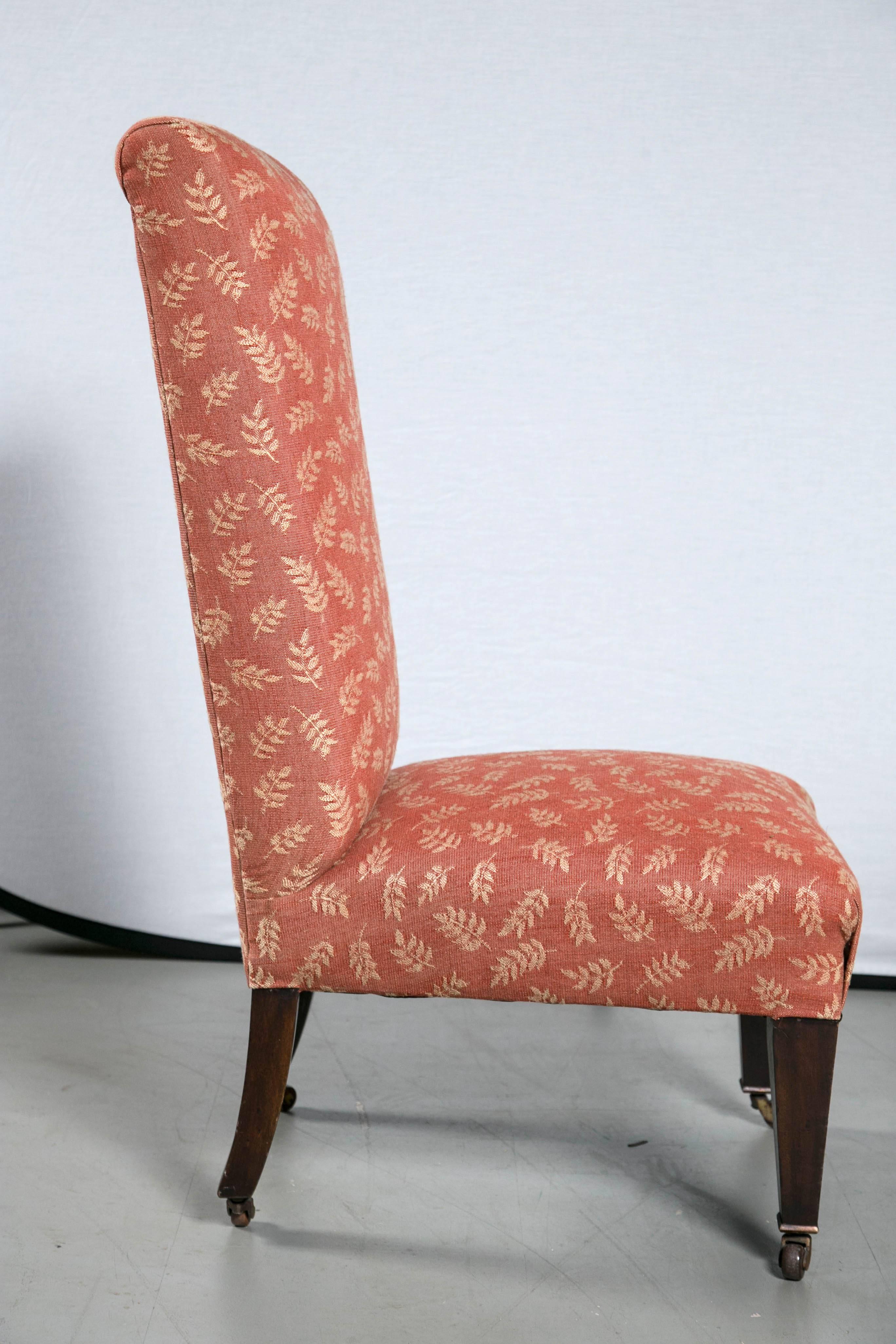 Late19th century upholstered high back chair English with brass casters.