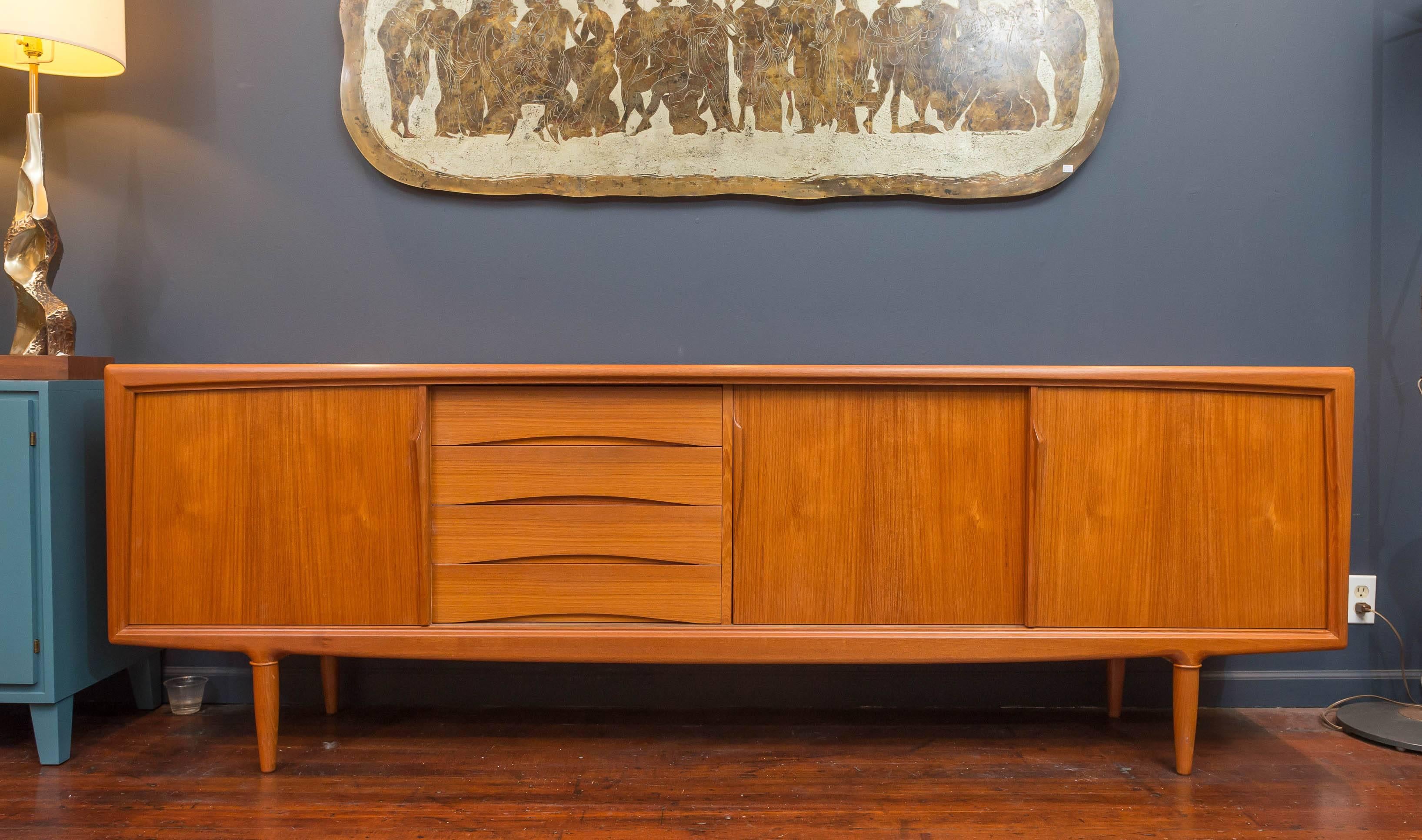 Danish modern teak credenza designed by Gunni Oman, fitted interiors and newly refinished.