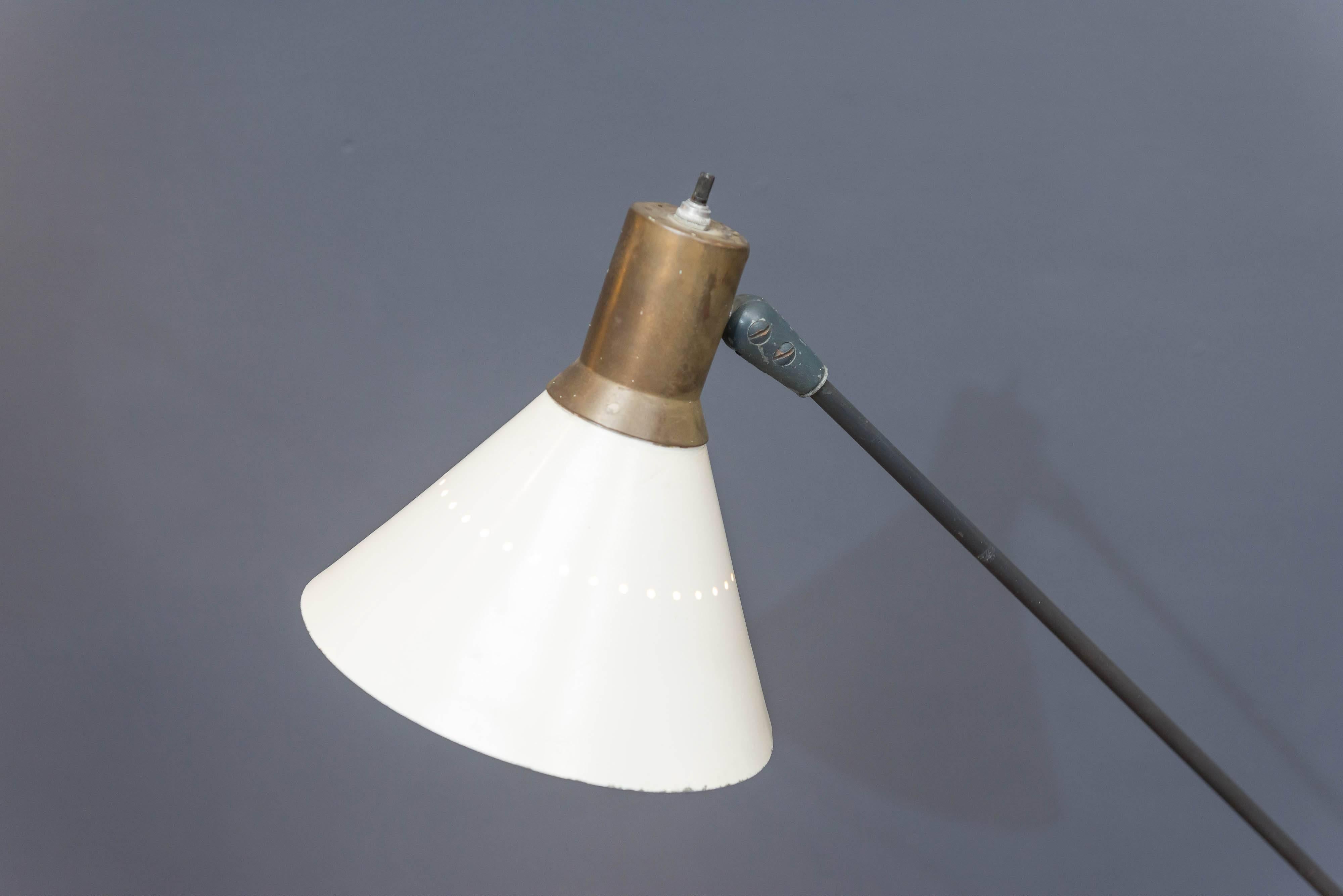 Designed by Gilbert Watrous for the Heifetz Lighting Company and one of the ten winners of the low cost lighting competition of 1951. Retained by the museum of modern art for there permanent collection. 
Tripod base supports a single adjustable arm