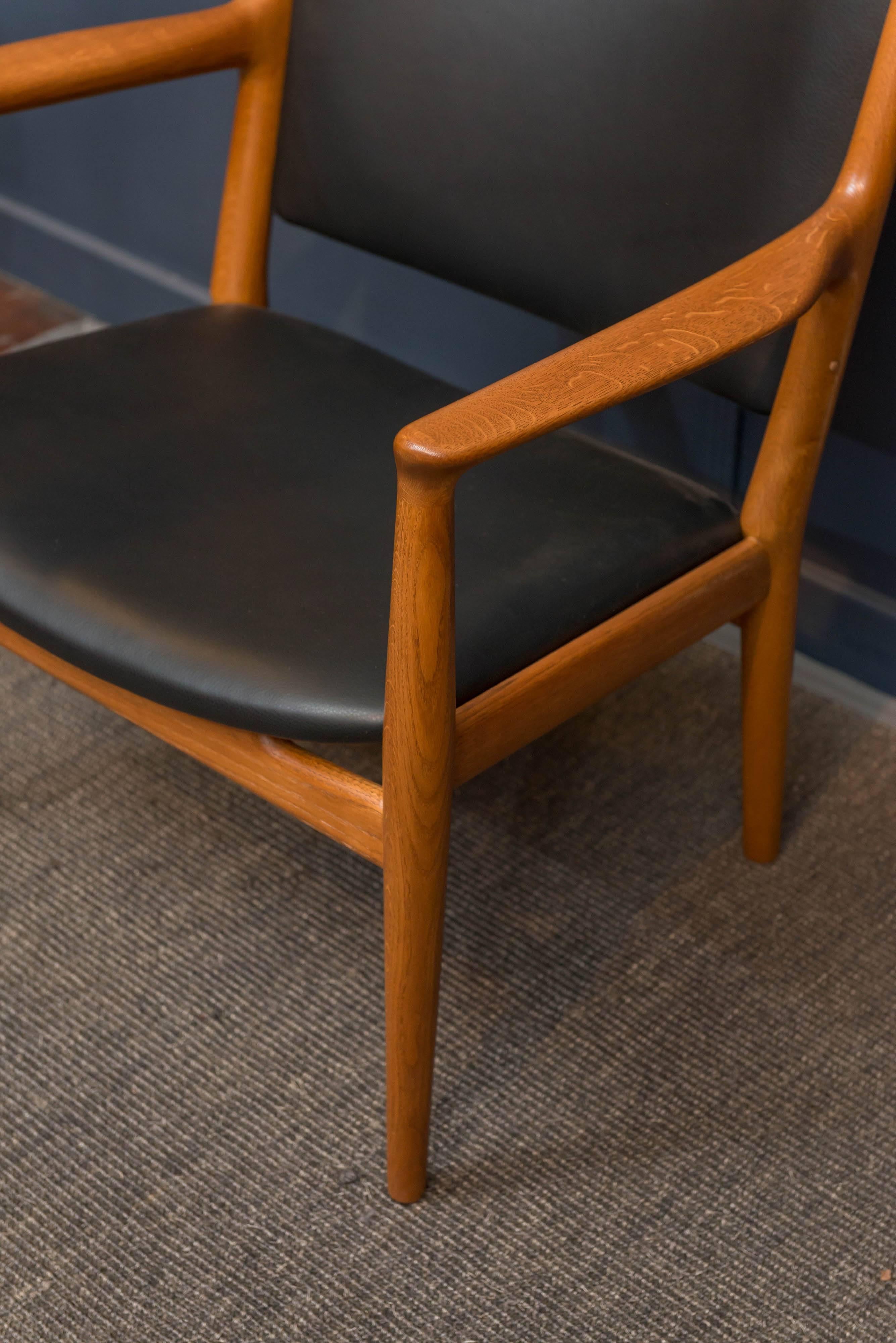 Hans J Wegner design oak and teak lounge chair model JH-713 for Johannes Hansen, Denmark.
Simple elegance combined with high quality construction and restorations make for the perfect robust lounge chair. 
New leather upholstery, labeled.