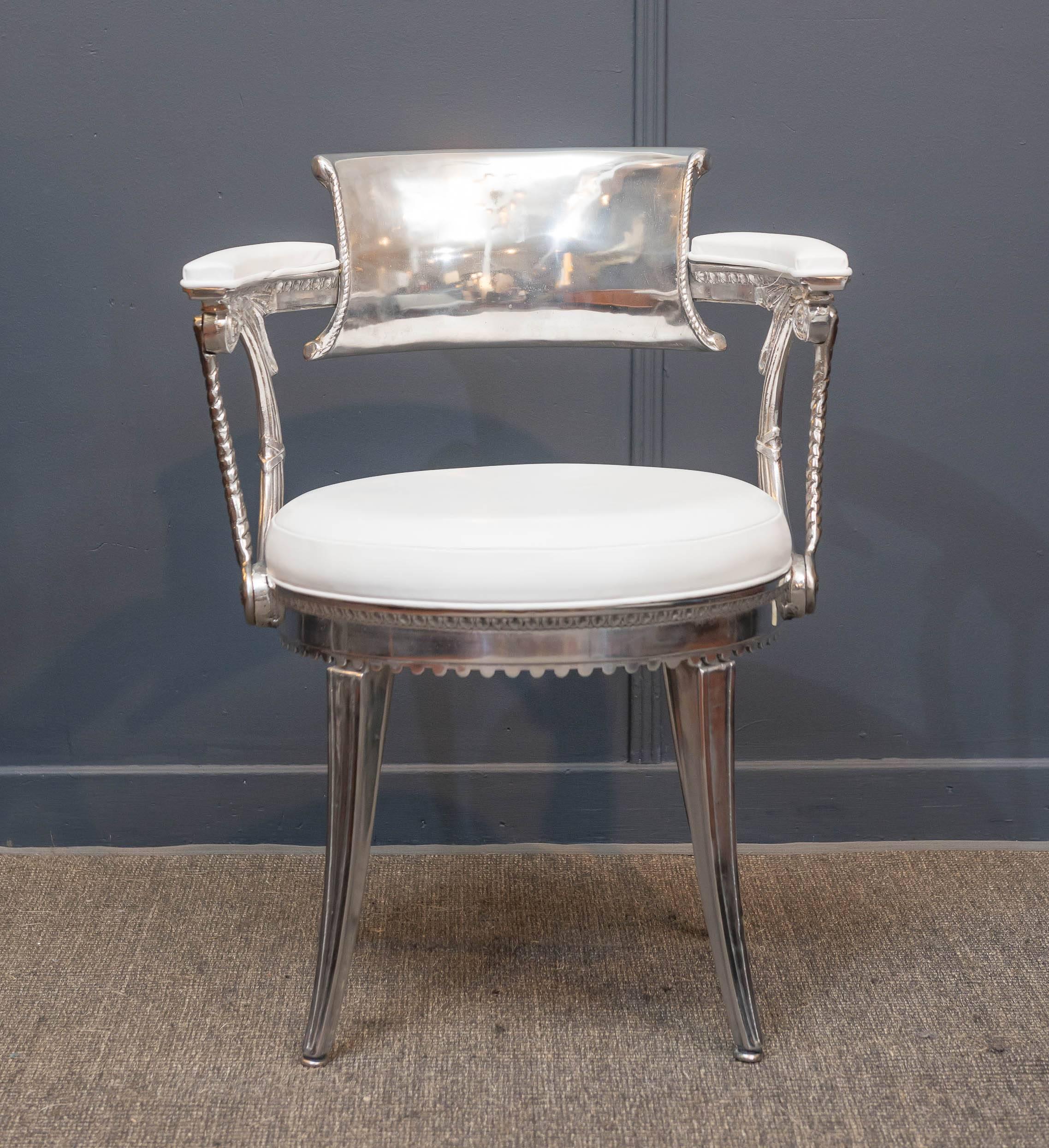 Pair of rare Dorothy Draper design armchairs from the highly acclaimed commission for Fairmont Hotel in San Francisco, 1947. 
The armchairs adorn a crown on the back which signifies they were used in the Crown dining room.

Polished cast aluminum