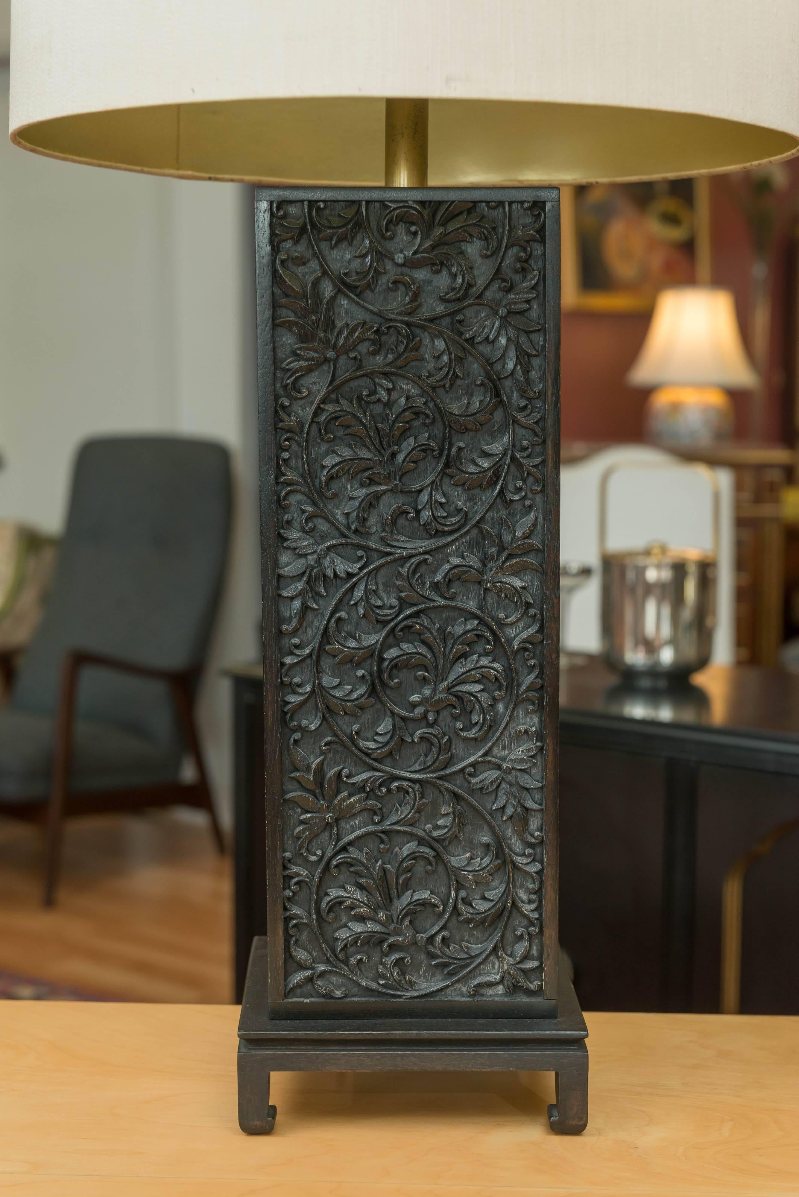 A pair of ebonized Oak table lamps in the style of James Mont. Handcrafted scroll motif filigree, on a Chow-leg style base. Lamps are circa 1950s, very Chinese modern. Original shades, and finals, height measurement below is to top of shade.