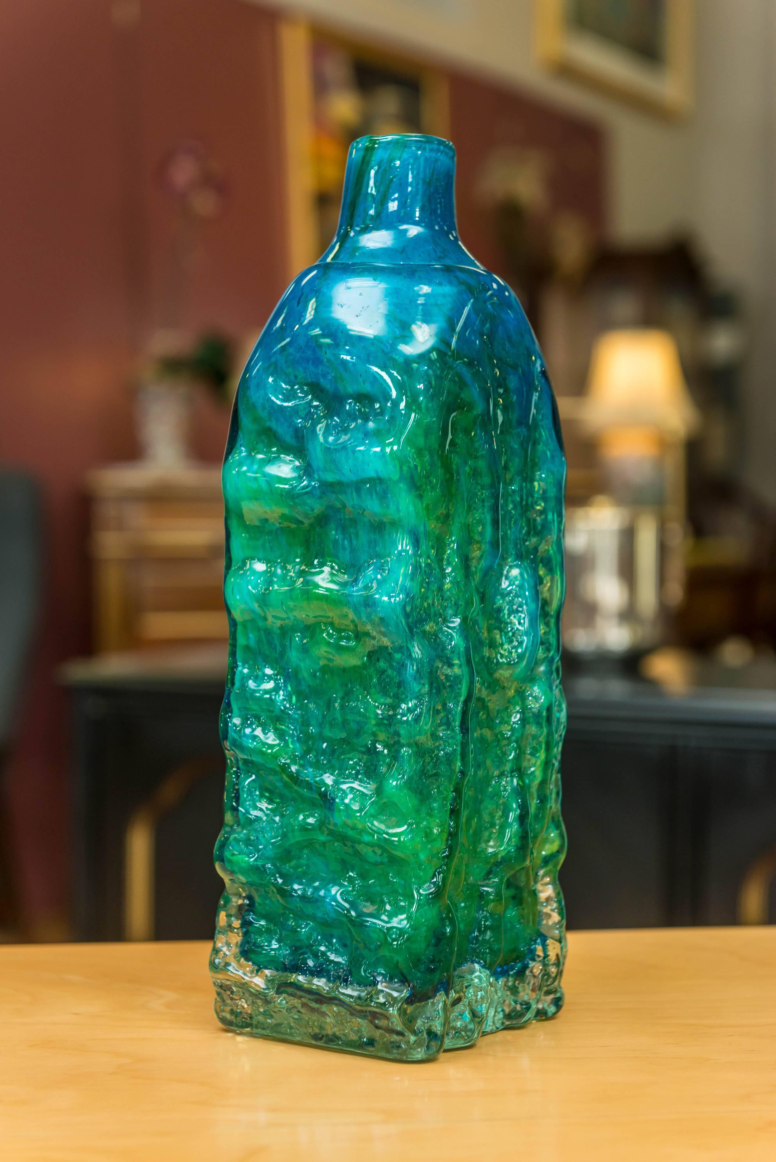 An uncommon and influential large glass bottle vase designed by Royal College of Art lecturer and Maltese Glass Industries – soon rechristened Mdina Glass – founder Michael Harris (1933-1994). Inspired by Scandinavian artisans and environs while