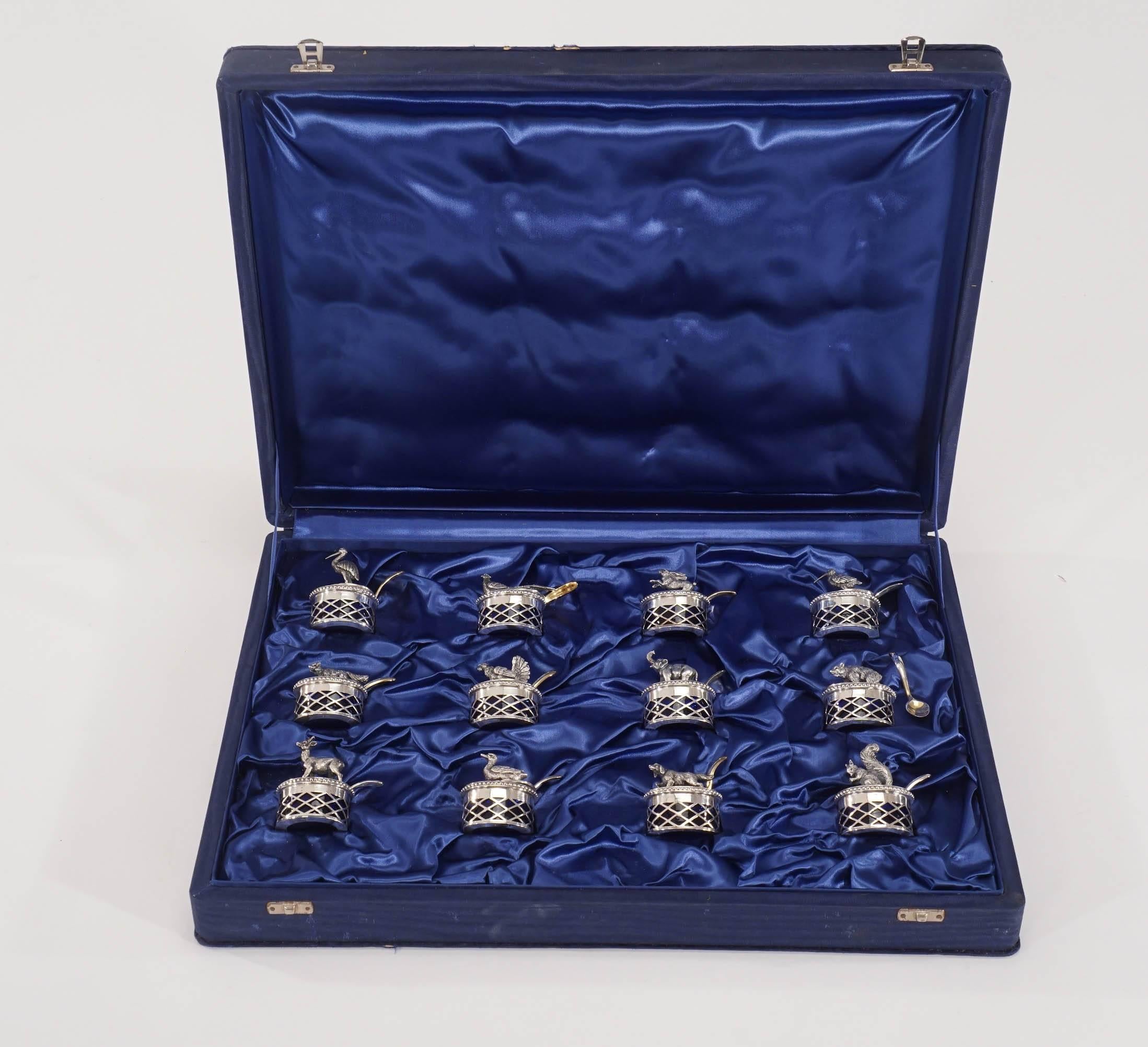 This is the most unusual set of covered salts I have had the pleasure to own. They are a combination of handblown cobalt crystal salts in pierced .800 silver holders, each with a figural game animal perched on the lids. To top them off, each lid