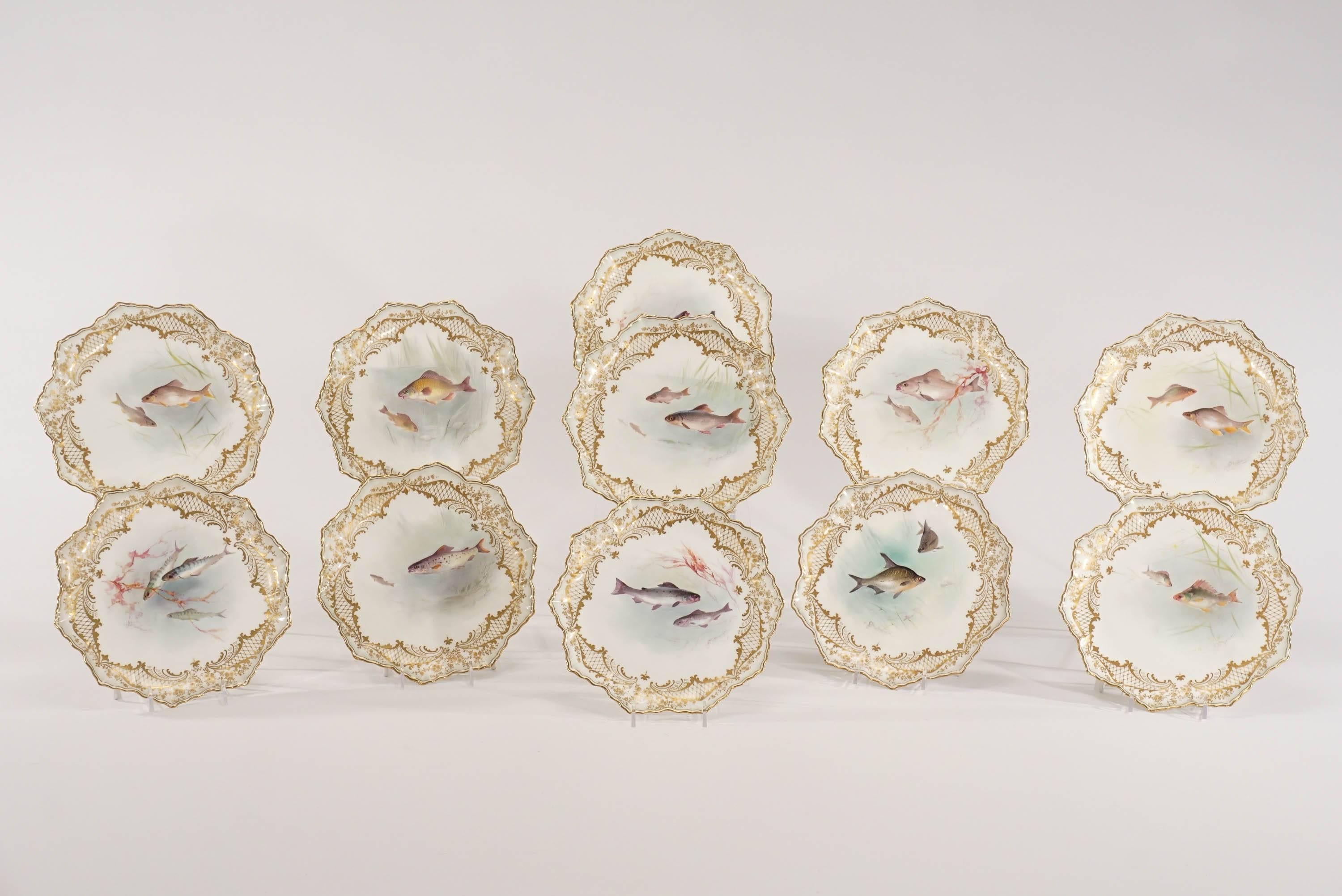 A lovely set of 11 hand painted and artist signed plates with shaped rims and trimmed with raised paste gold. The interesting 10-pointed border creates a lovely framework around the central marine life subjects, each uniquely painted with different
