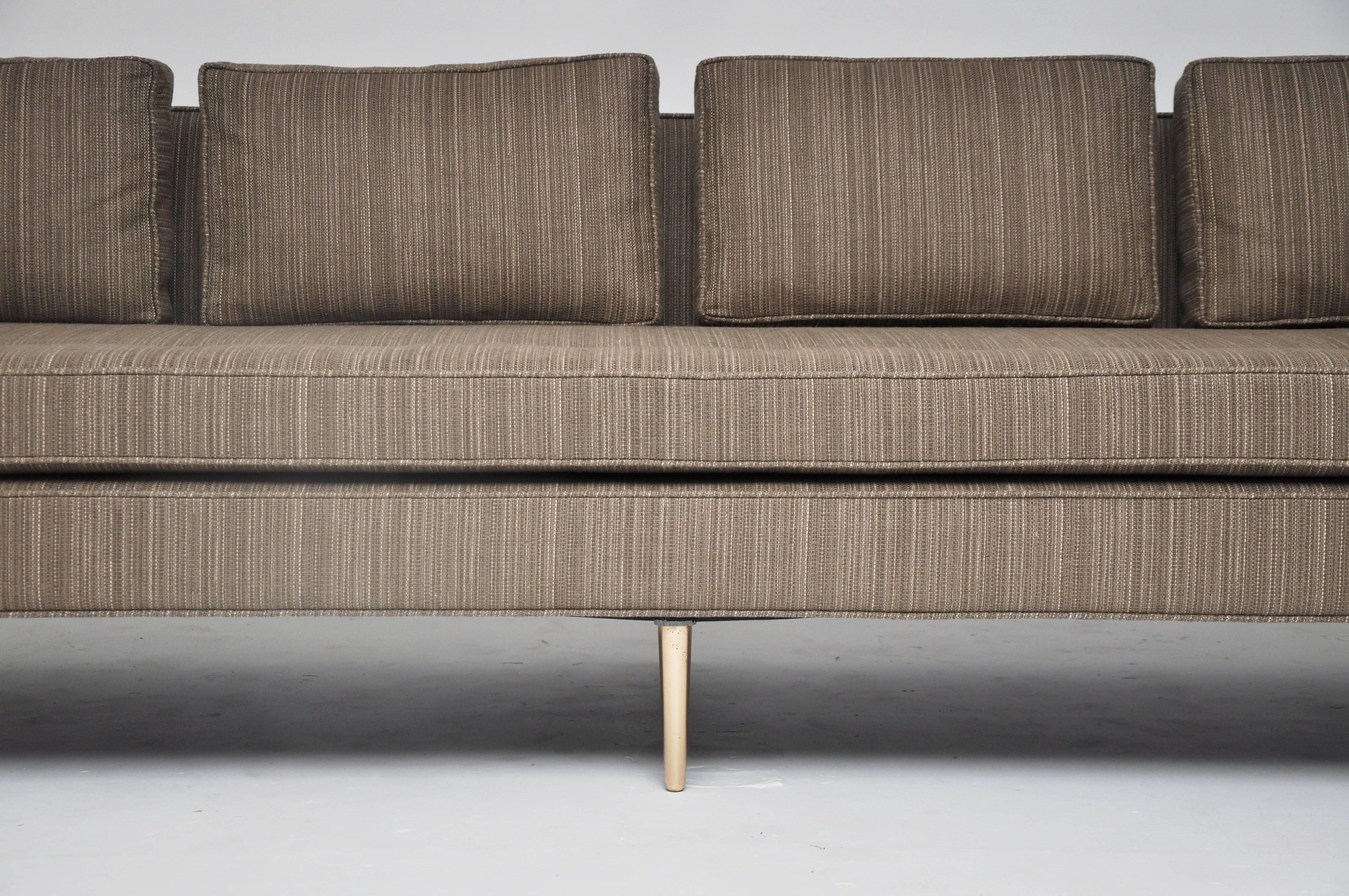 9' sofa on brass legs designed by Edward Wormley for Dunbar. Newly upholstered in horse hair fabric with down back cushions.