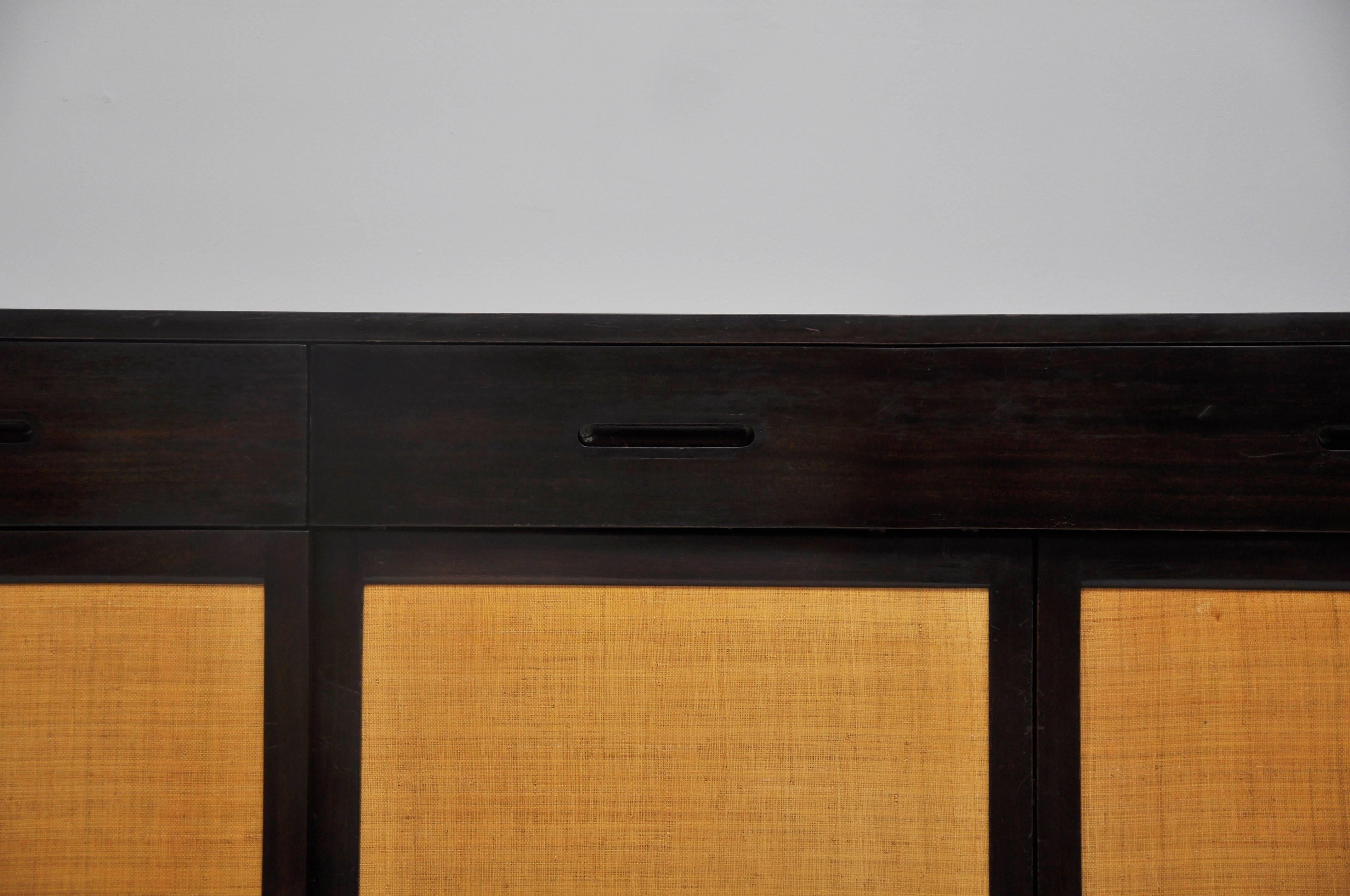 Sideboard designed by Edward Wormley for Dunbar, circa 1950s. Original finish dark espresso case with grasscloth doors.