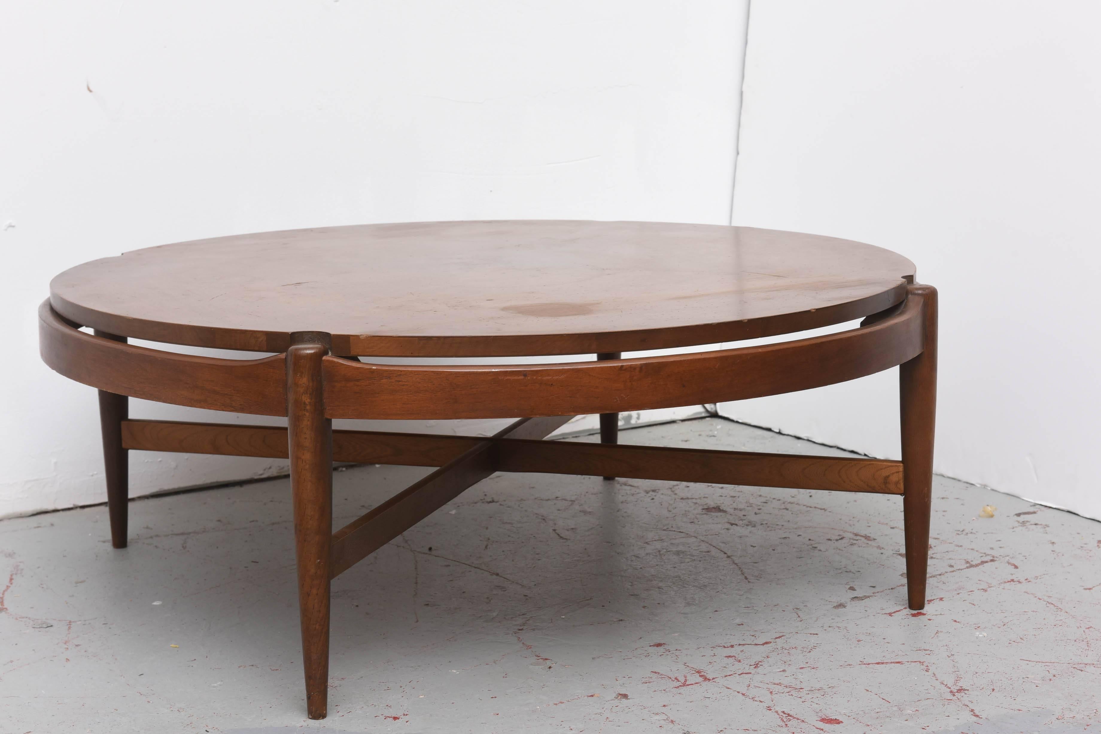 Beautiful round coffee table with cutouts in Walnut by Bassett.