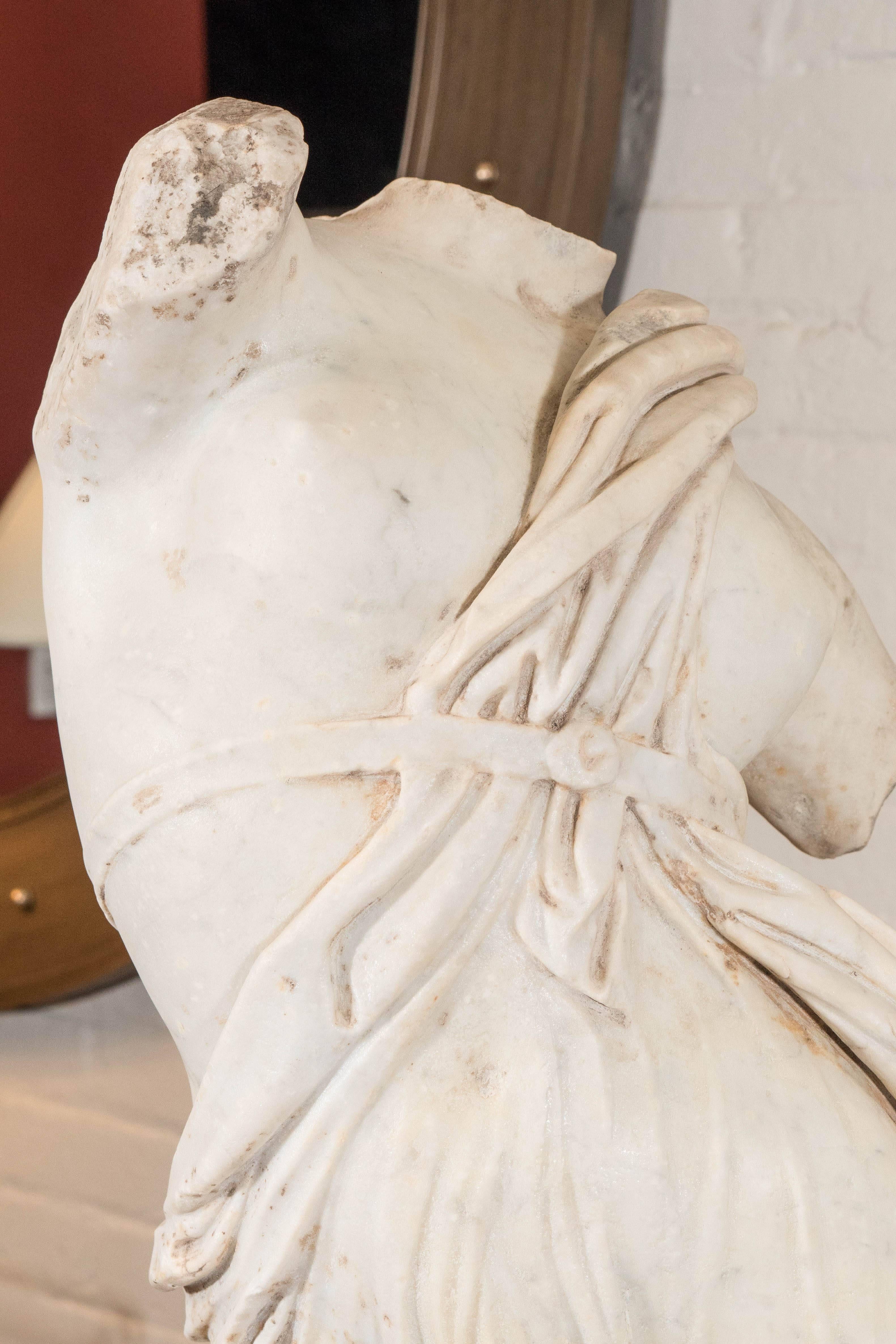 Marble torso of female maenad, a follower of Dionysus, in sensual sinuous pose with well-modeled wet drapery. Probably academy made after Skopas' raging maenad.

Measures: 32