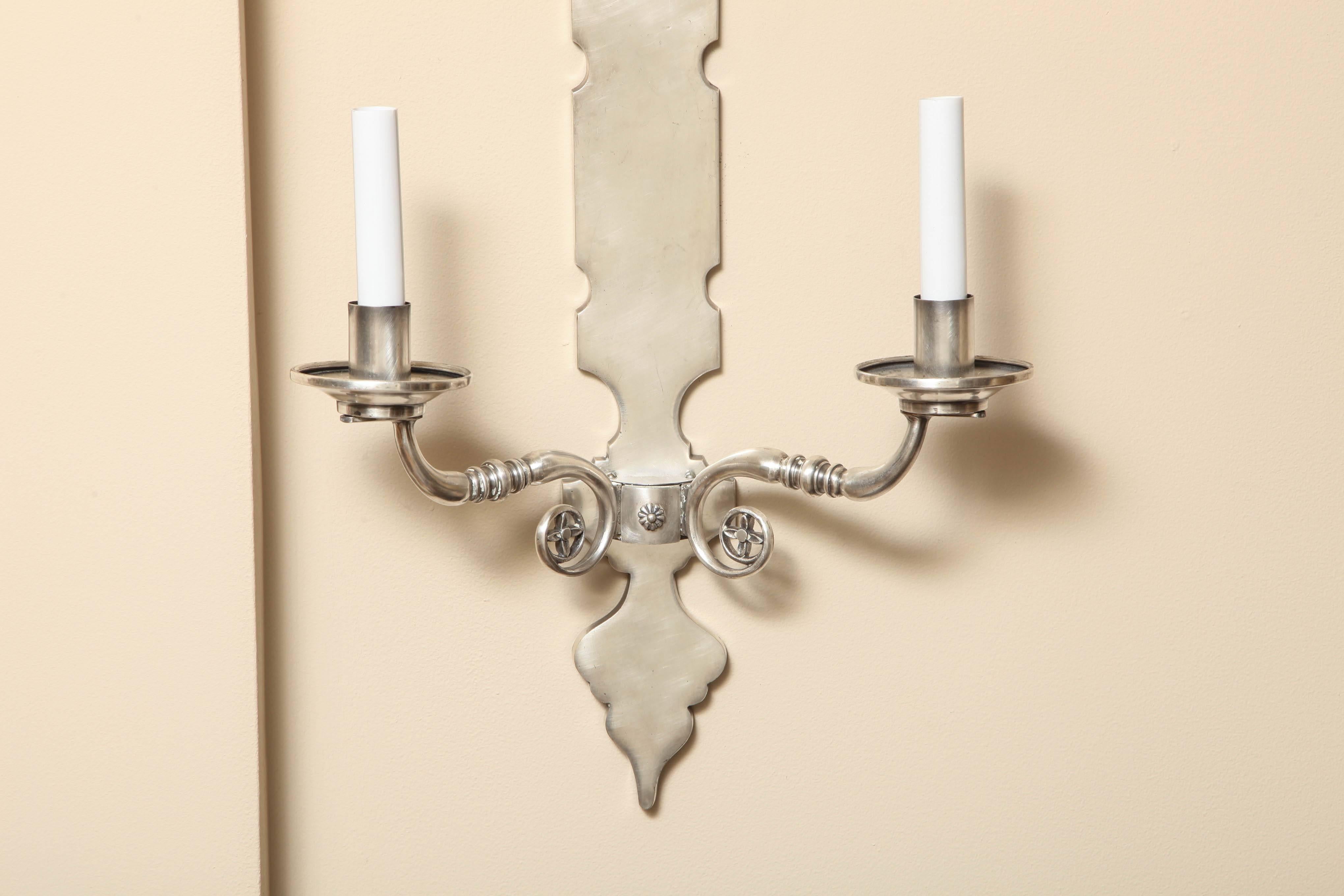 A pair of French two-light wall sconces with shaped 3