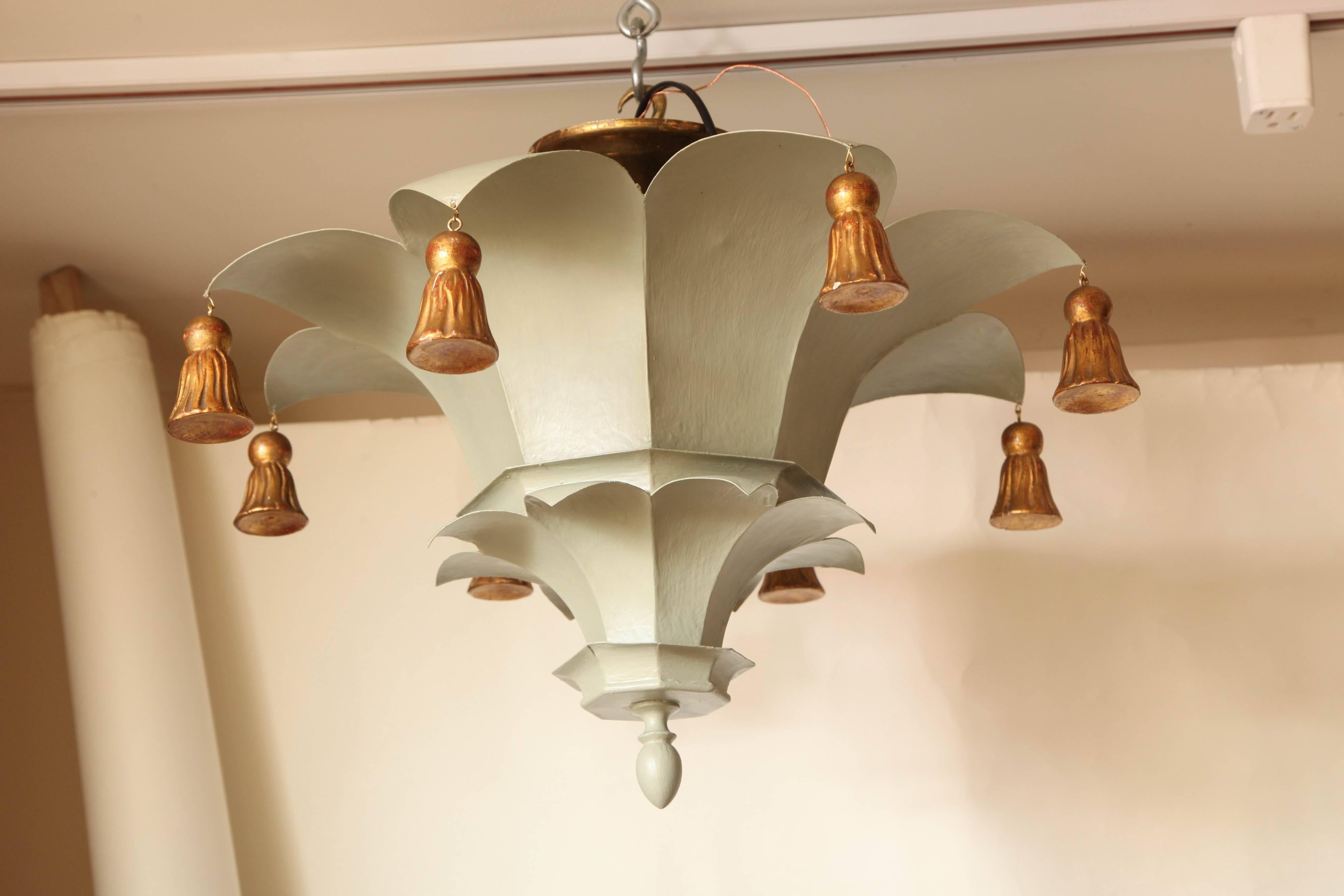 A French tole ceiling fixture in the form of an inverted celadon green Chinese parasol, each corner having a carved in gilt wood bells, interior fitted with two Edison sockets, maximum wattage 120 watts. Circa 1950.