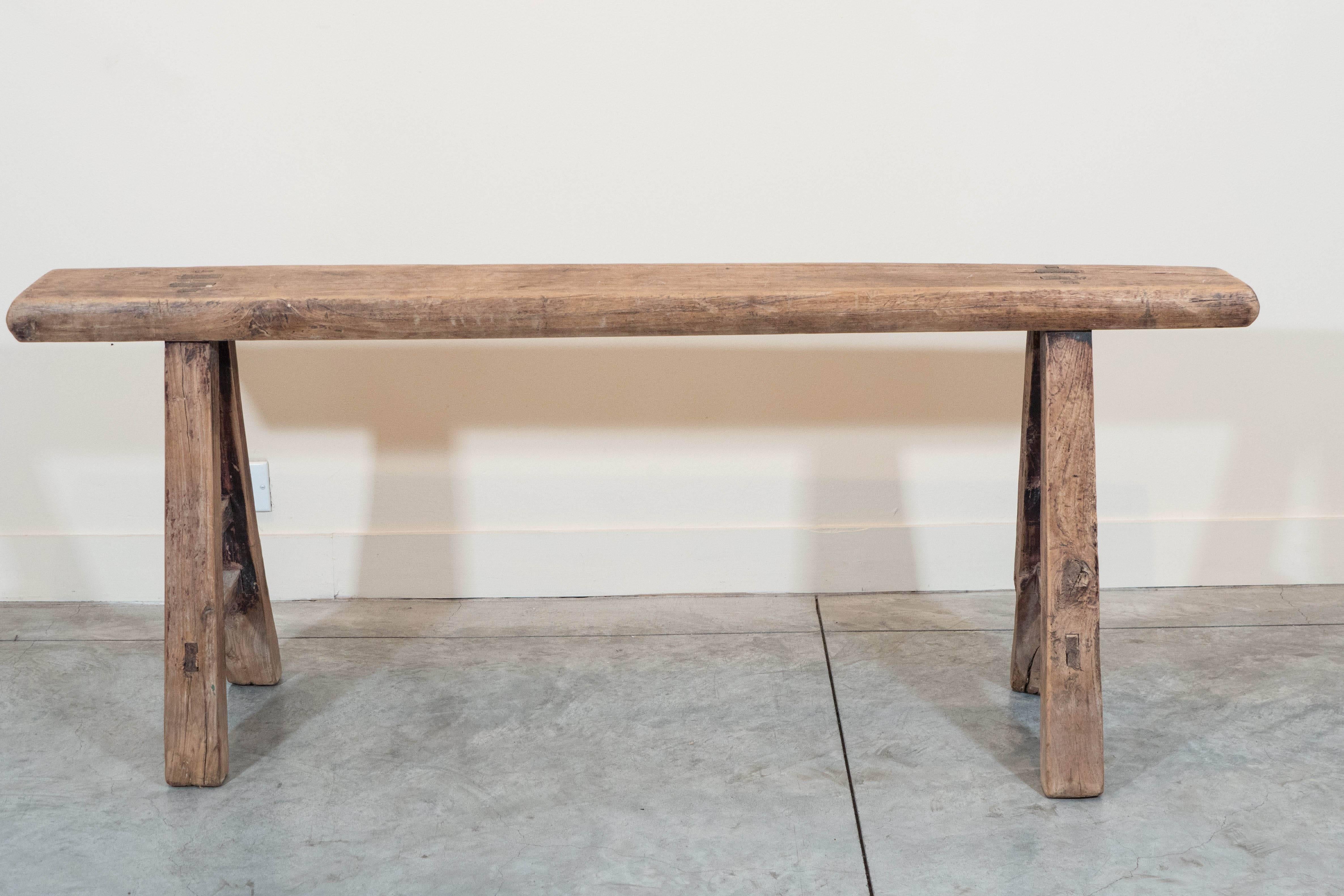 A narrow provincial bench with simple legs and sturdy seat.  From Shandong Province, c. 1900.
T587