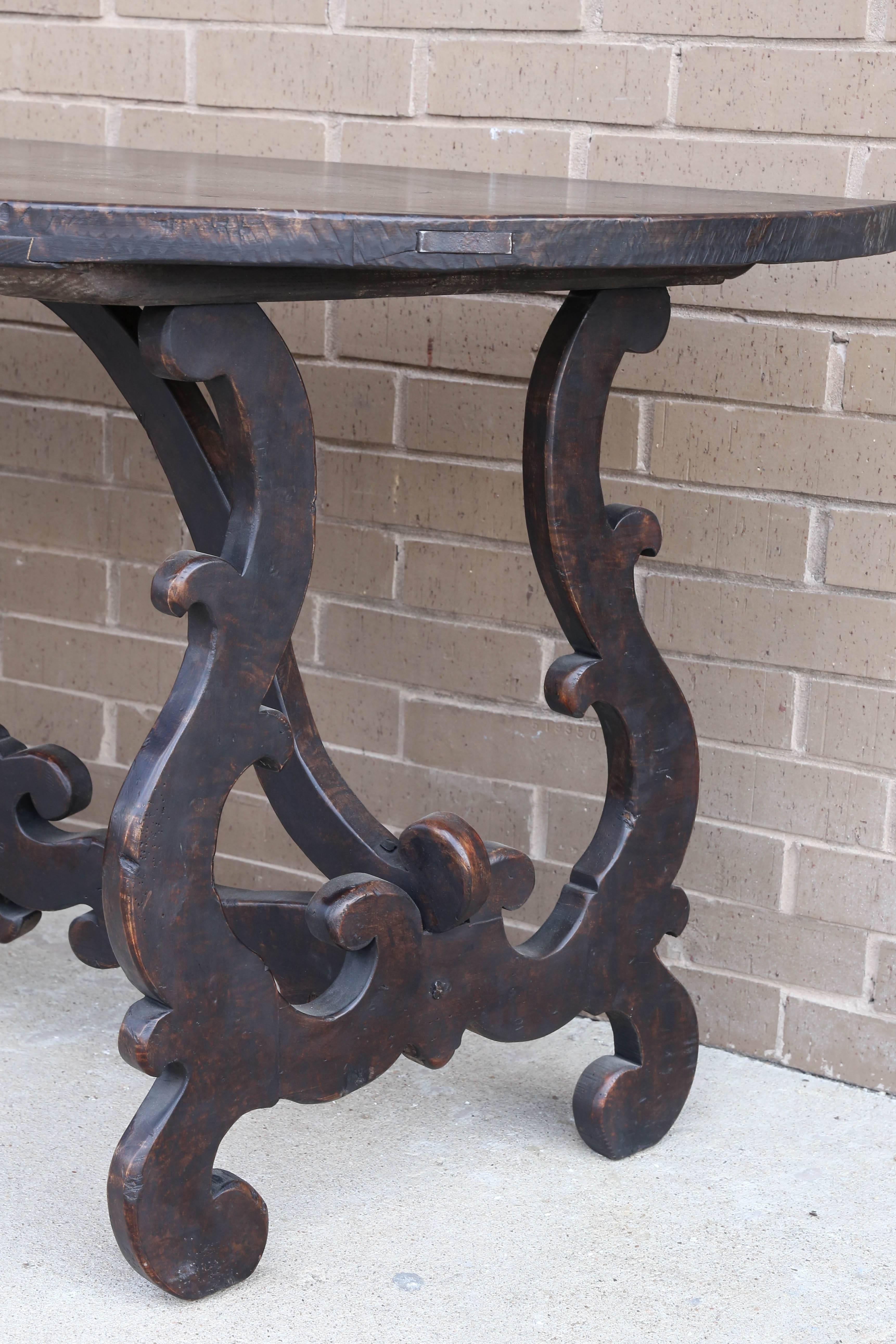This elegant walnut demilune table is from Italy and makes a statement with its rich dark wood. (Only one available).