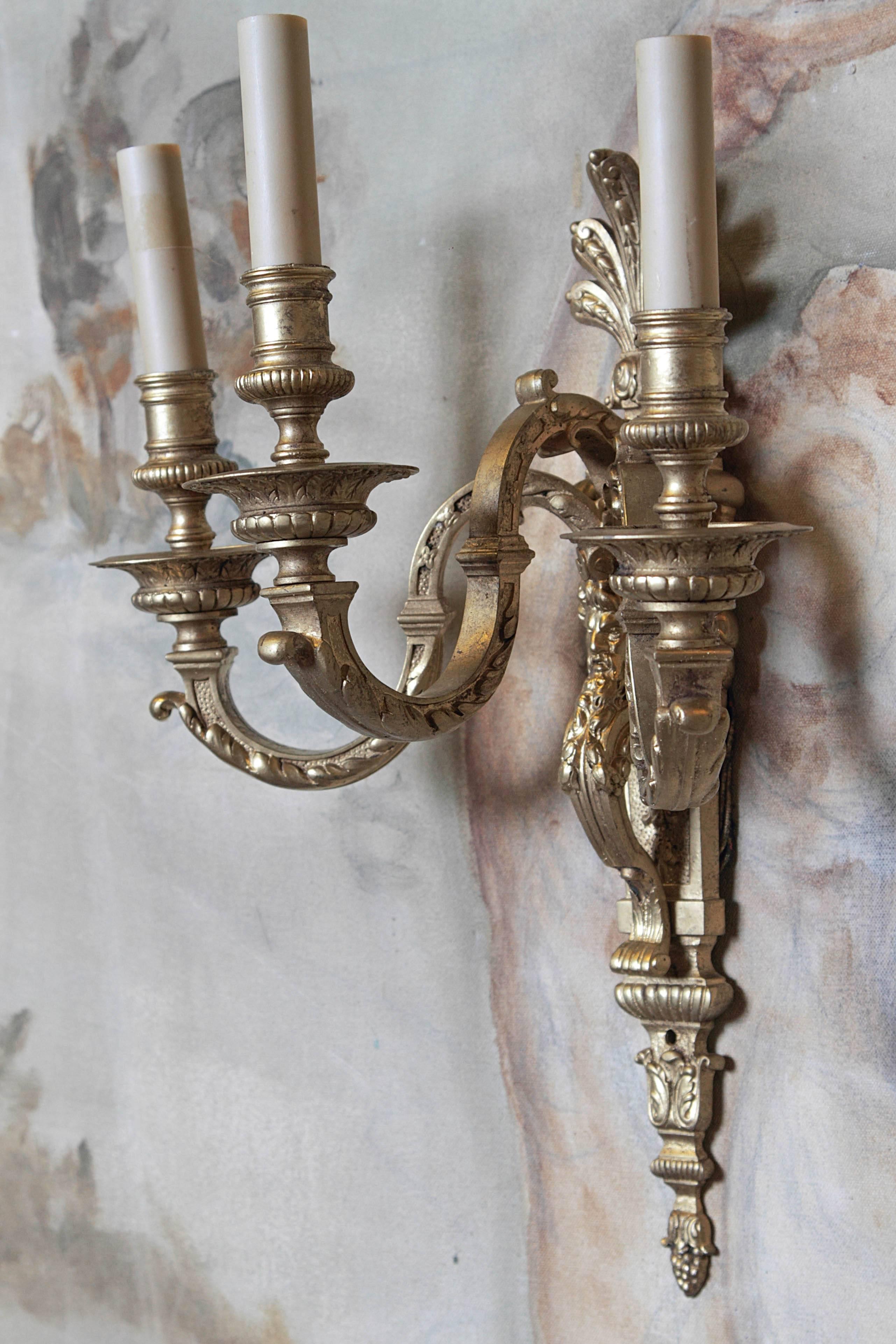 Pair of French bronze three-candle wall sconces with face motif.