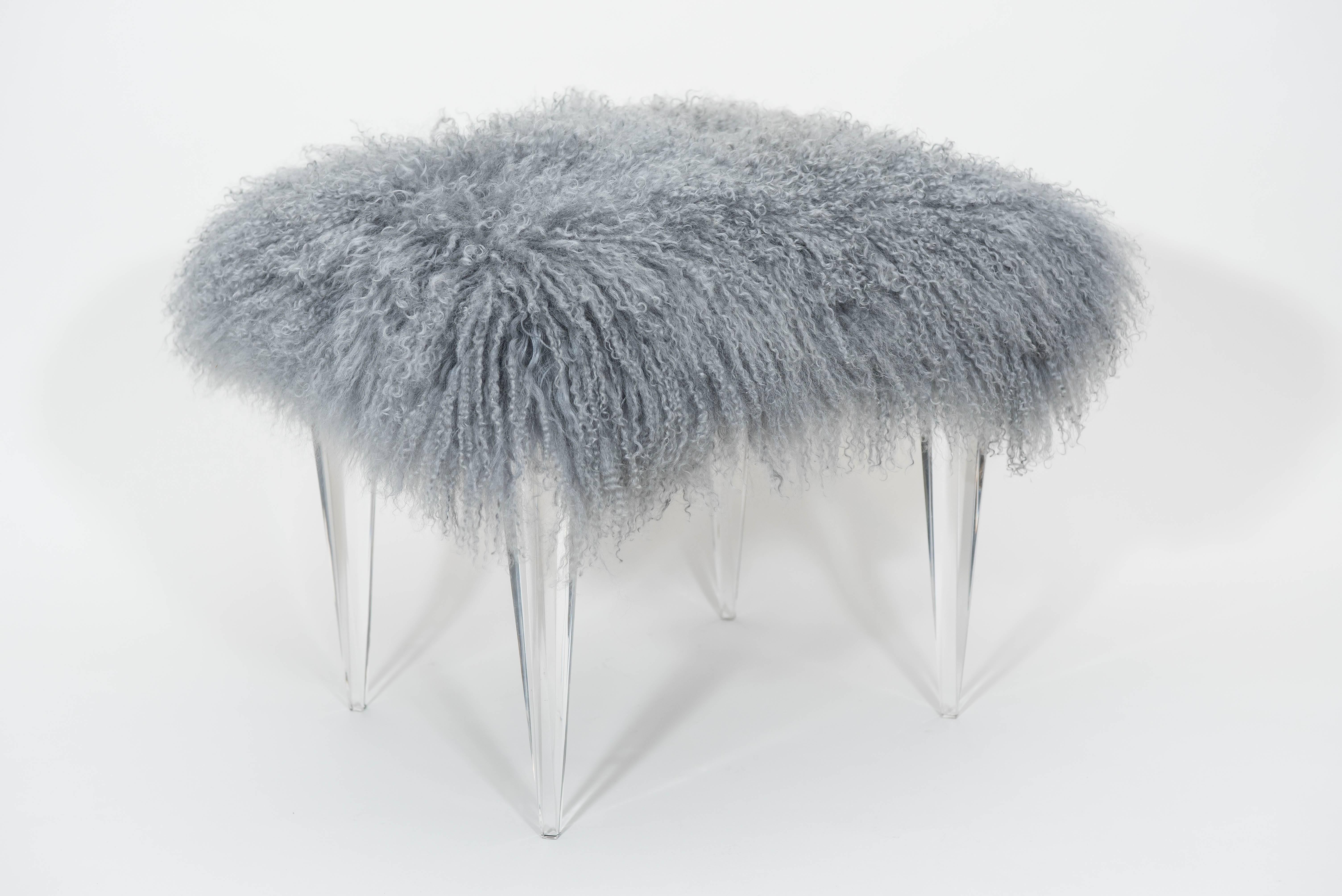This pair of custom foot stools with tapered acrylic legs
have been upholstered in grey Tibetan lambs wool and are fun
and functional.