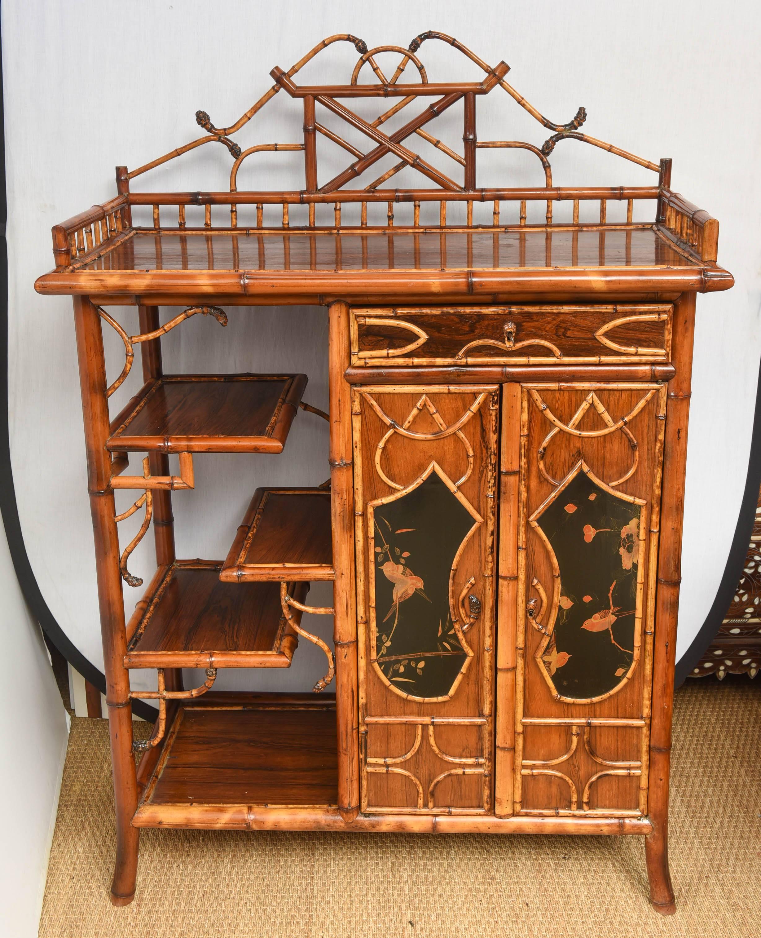 Superb English bamboo bookcase or cabinet with lacquer scene on doors and side. Beautiful bamboo roots on top.