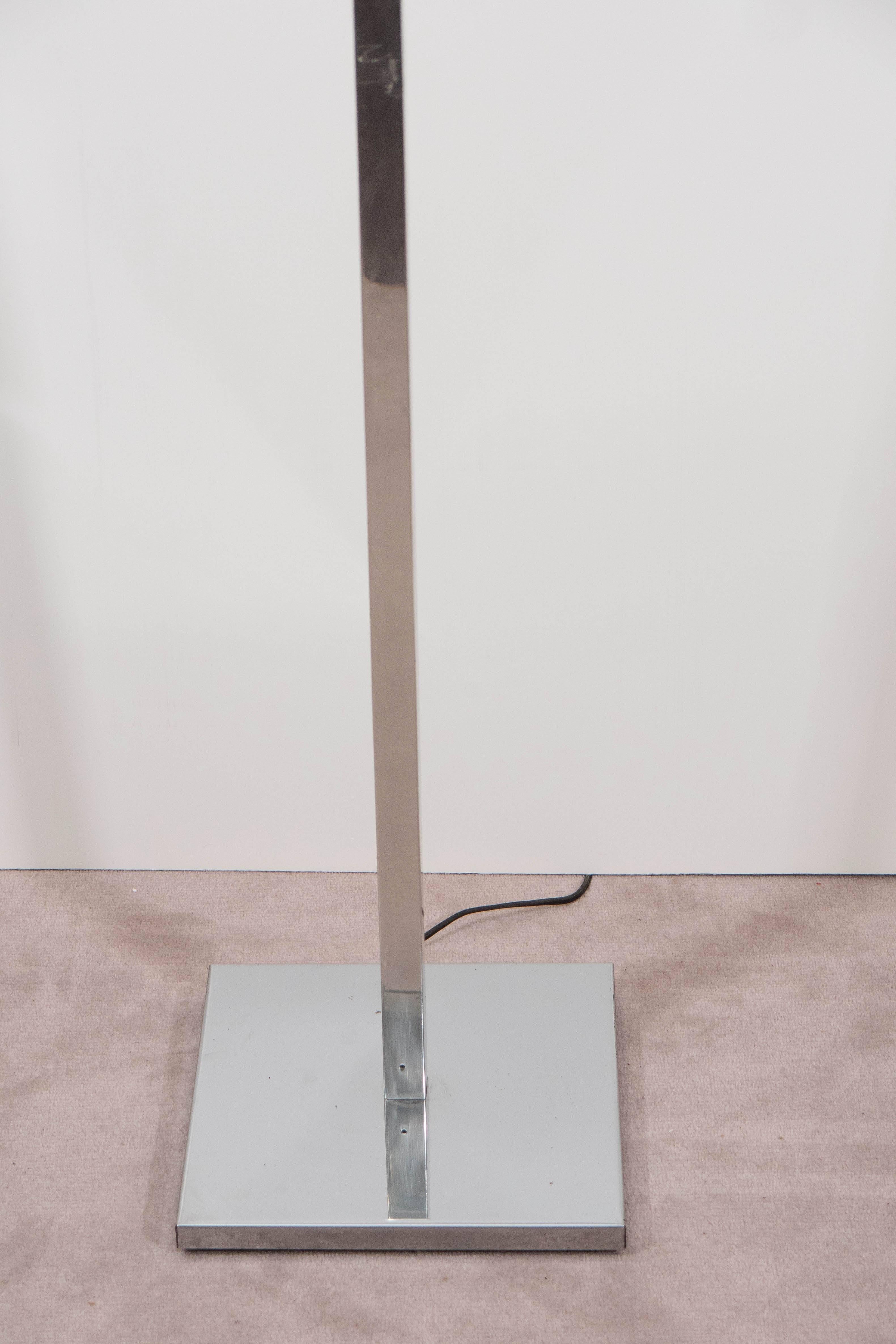 Pair of modernist floor lamp by Koch and Lowy, with three pivoting shades in polished chrome. Good vintage condition with a few minor scratches to stem. Shades extend to a maximum of 20" width. Base is 10" square.