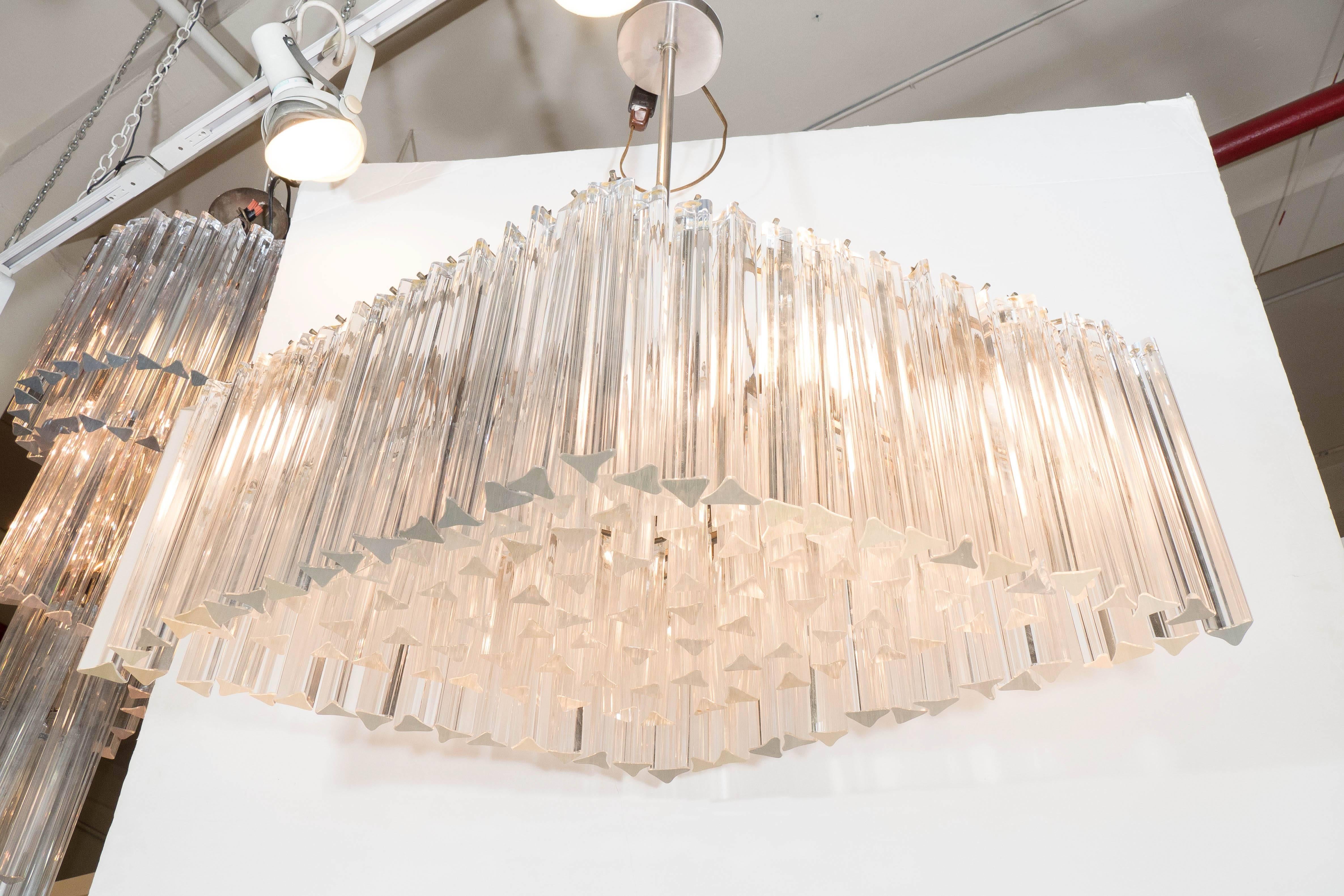 A vintage 1960s Italian chandelier by Venini, with Murano glass triedri prisms, suspended in a diamond formation, from a chrome frame. Wiring and sockets to US standard. Good vintage condition, consistent with age and use, with minimal wear to glass