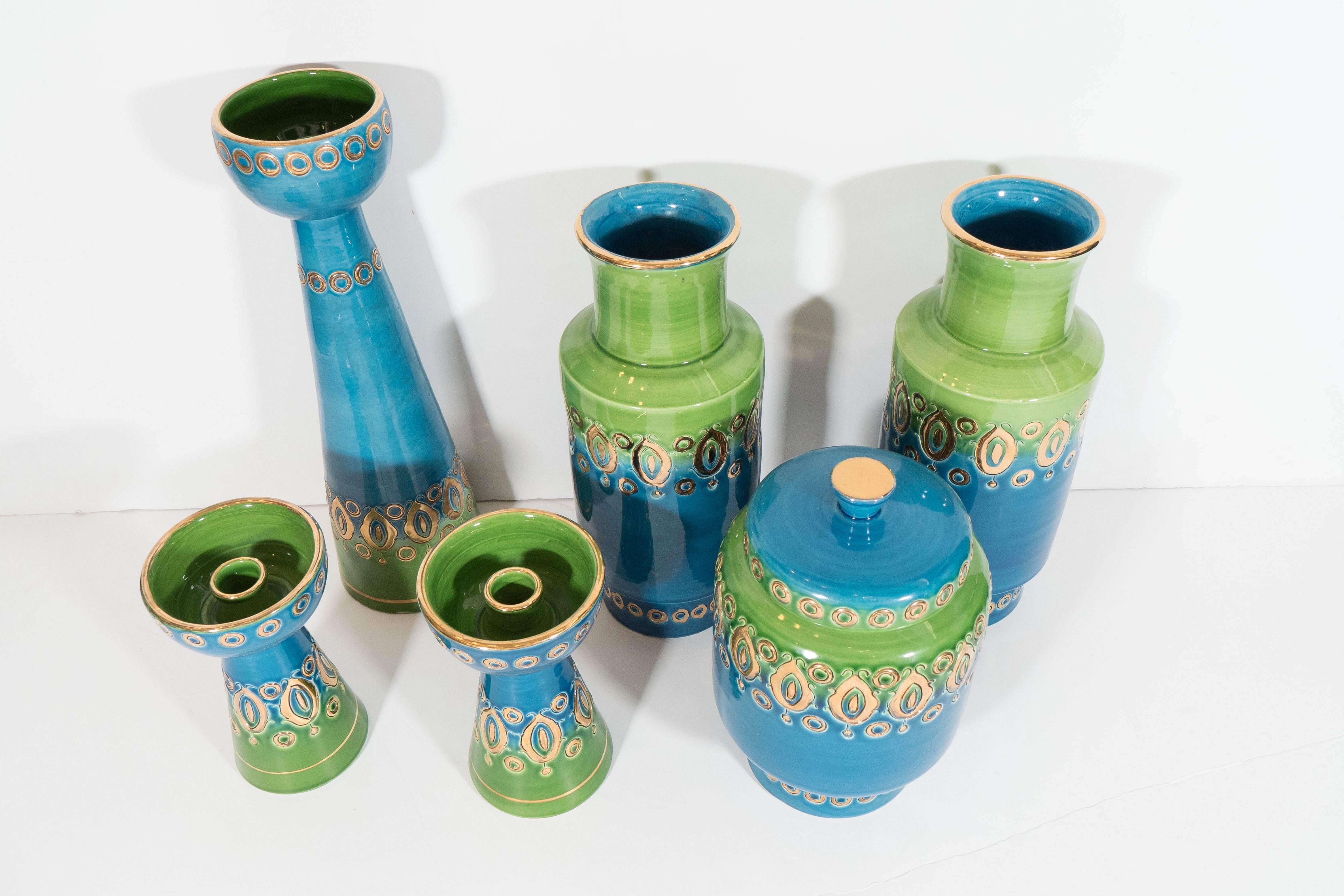 Set of vintage glazed ceramic objects, made by Bitossi during the 1960s and imported by Rosenthal-Netter, including a tall candleholder, a pair of vases, a lidded jar and two small candleholders; each piece is glazed in brilliant blue and green,