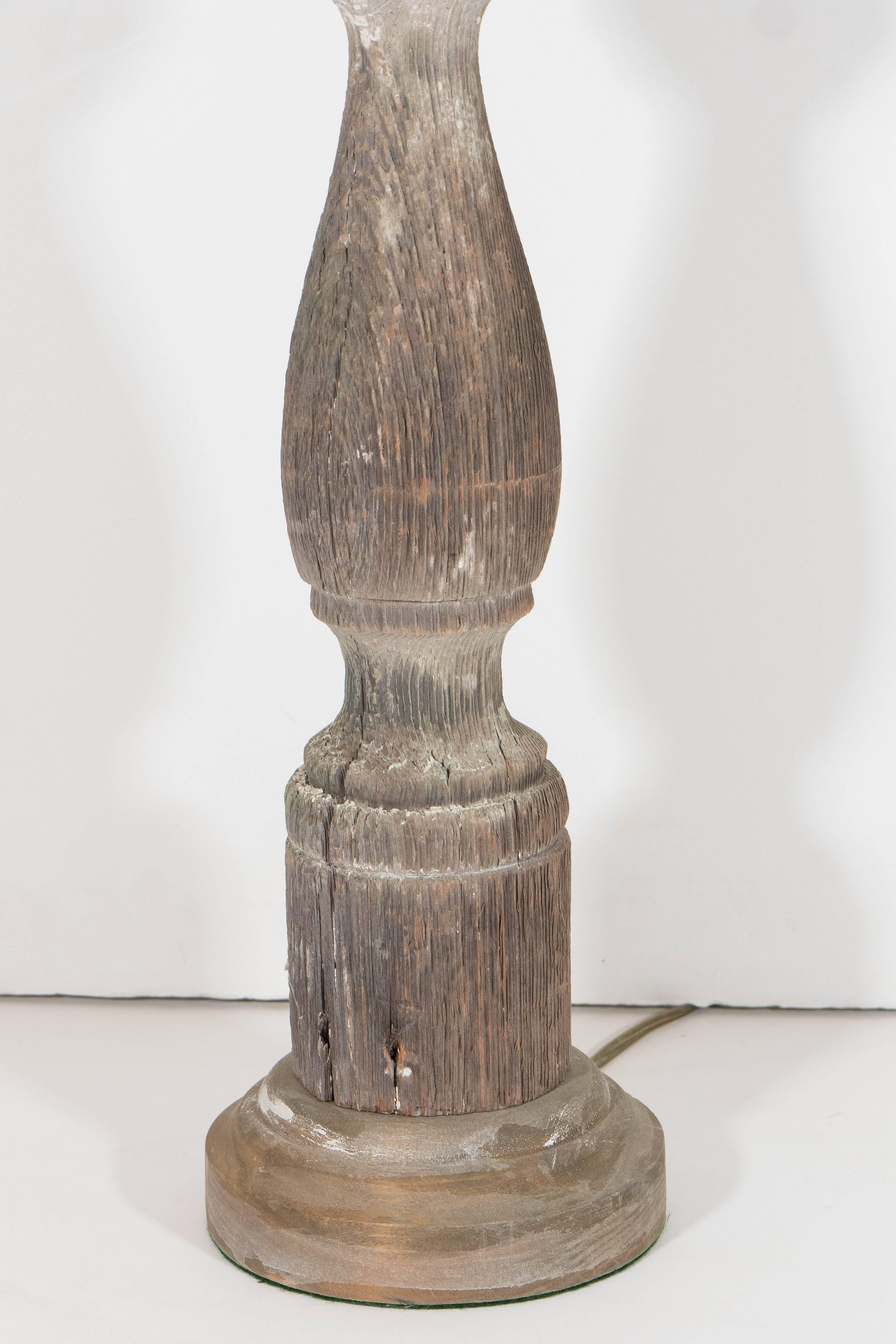 A pair of table lamps, with antique baluster bodies in wood; originally produced circa 1900s, the balusters have been remade as lamps, each retaining a beautifully weathered appearance. Wiring to US standard, each requires a single Edison base bulb.