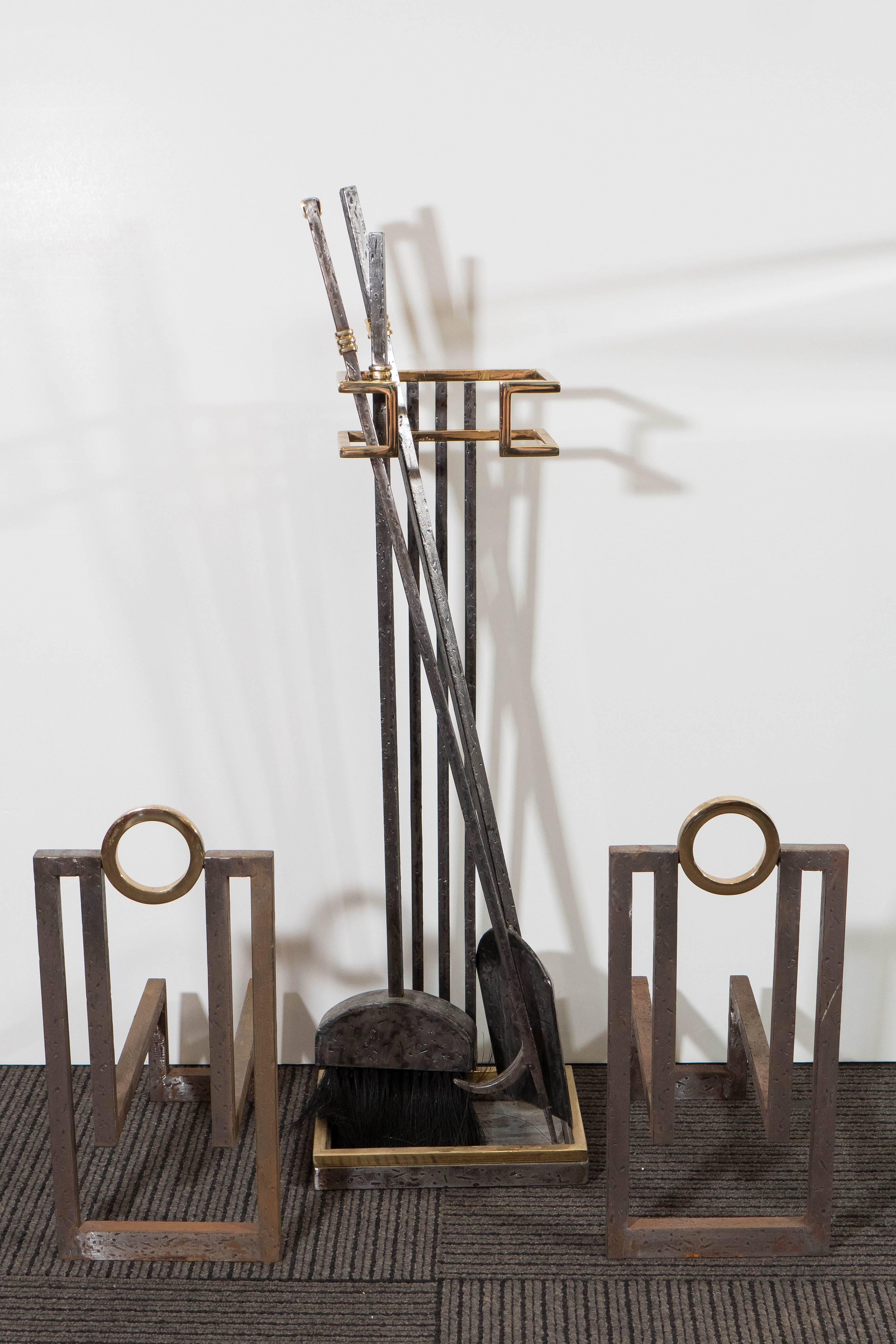 A highly modernistic fireplace arrangement, produced circa 1980s, including a pair of andirons and a set of tools on stand, with brush, shovel and poker, in mixed metals, wrought iron and brass. Overall good condition, presence of wear and some