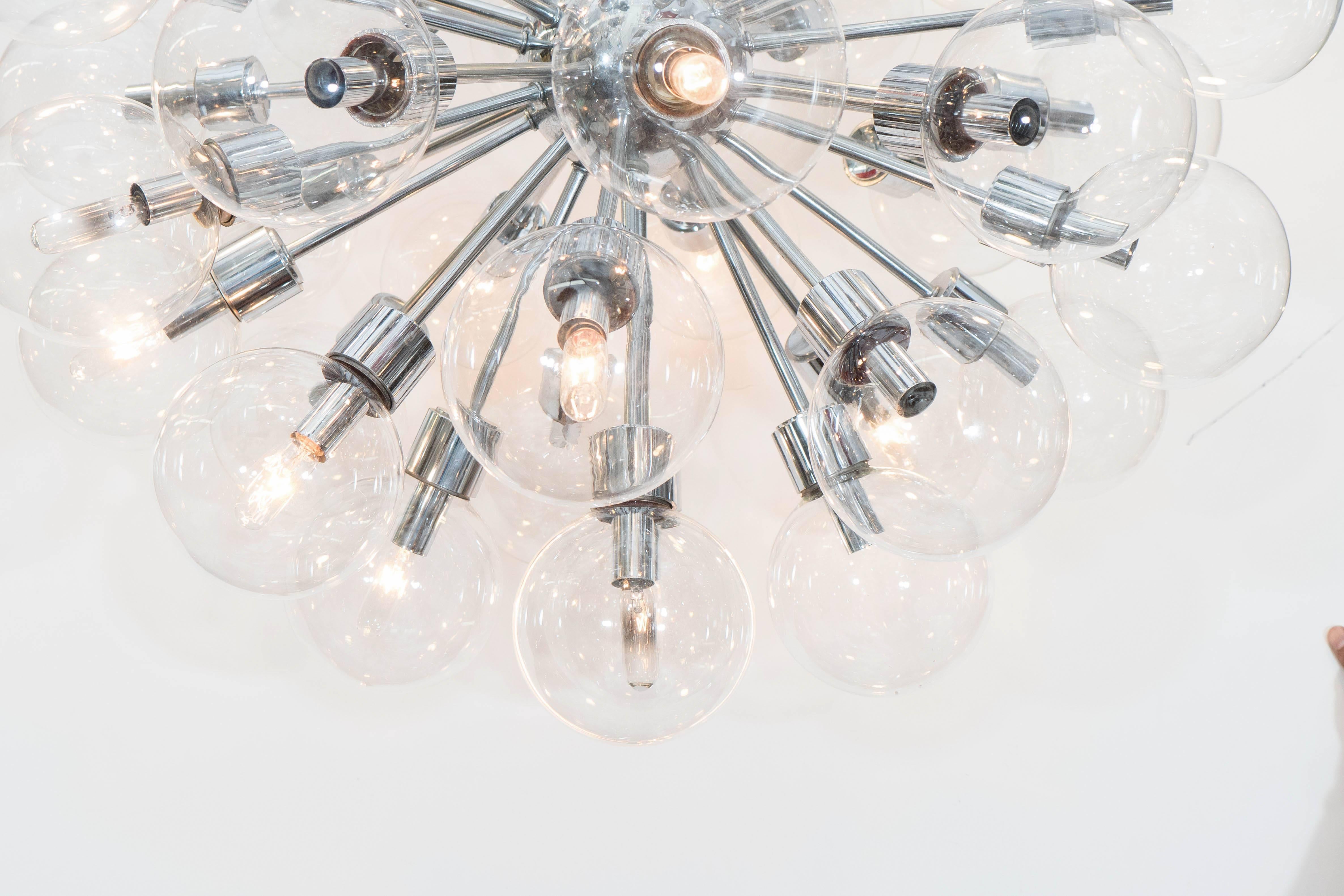 A large-scale chrome frame Sputnik chandelier, produced circa 1960s by Lightolier, with surrounding glass globe shades, radiating from a central nucleus. Very good vintage condition, consistent with age and use.