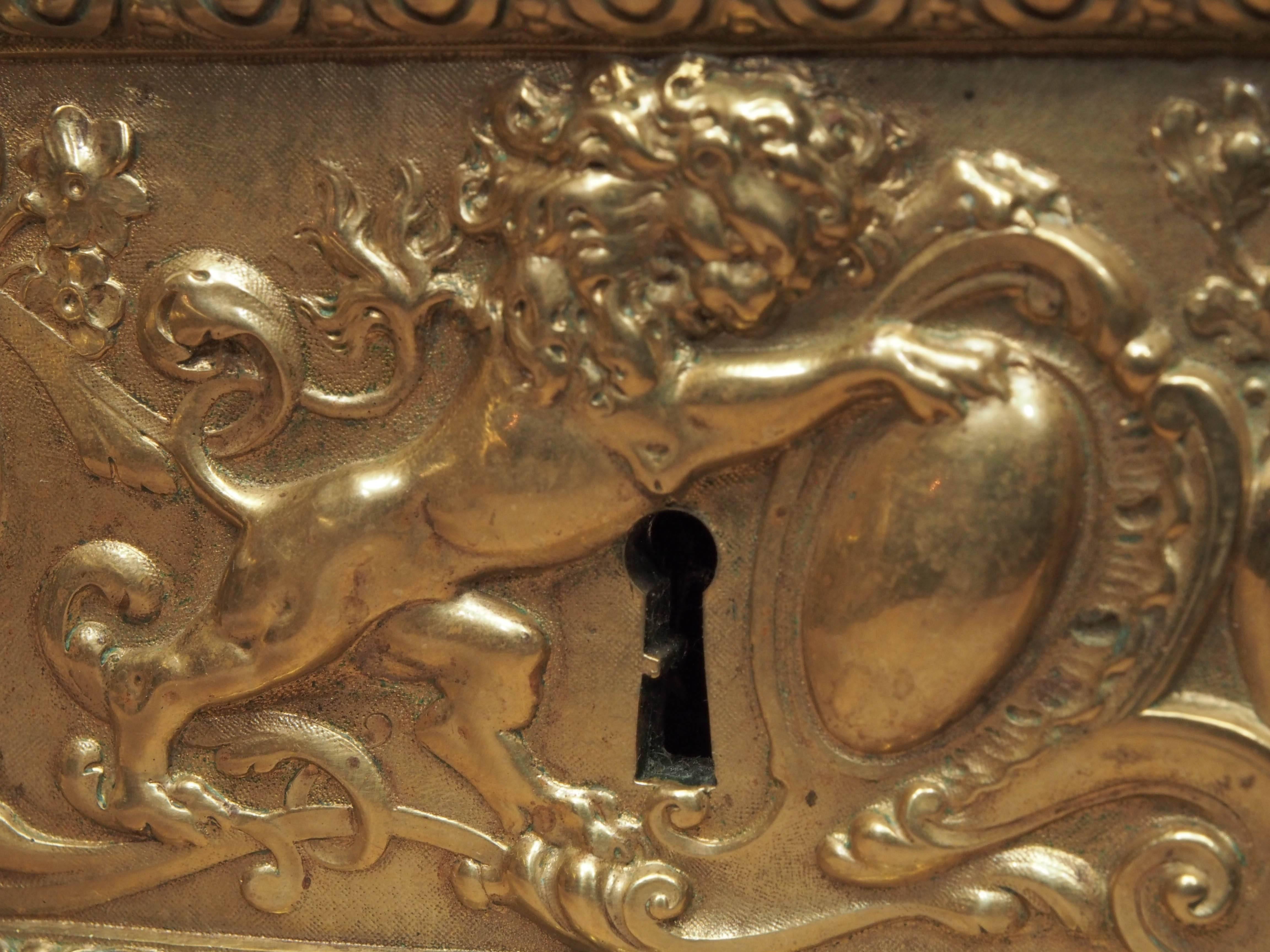 18th century French cast bronze door lock with and "egg and dart" borders, lion and double knobs, circa 1780.