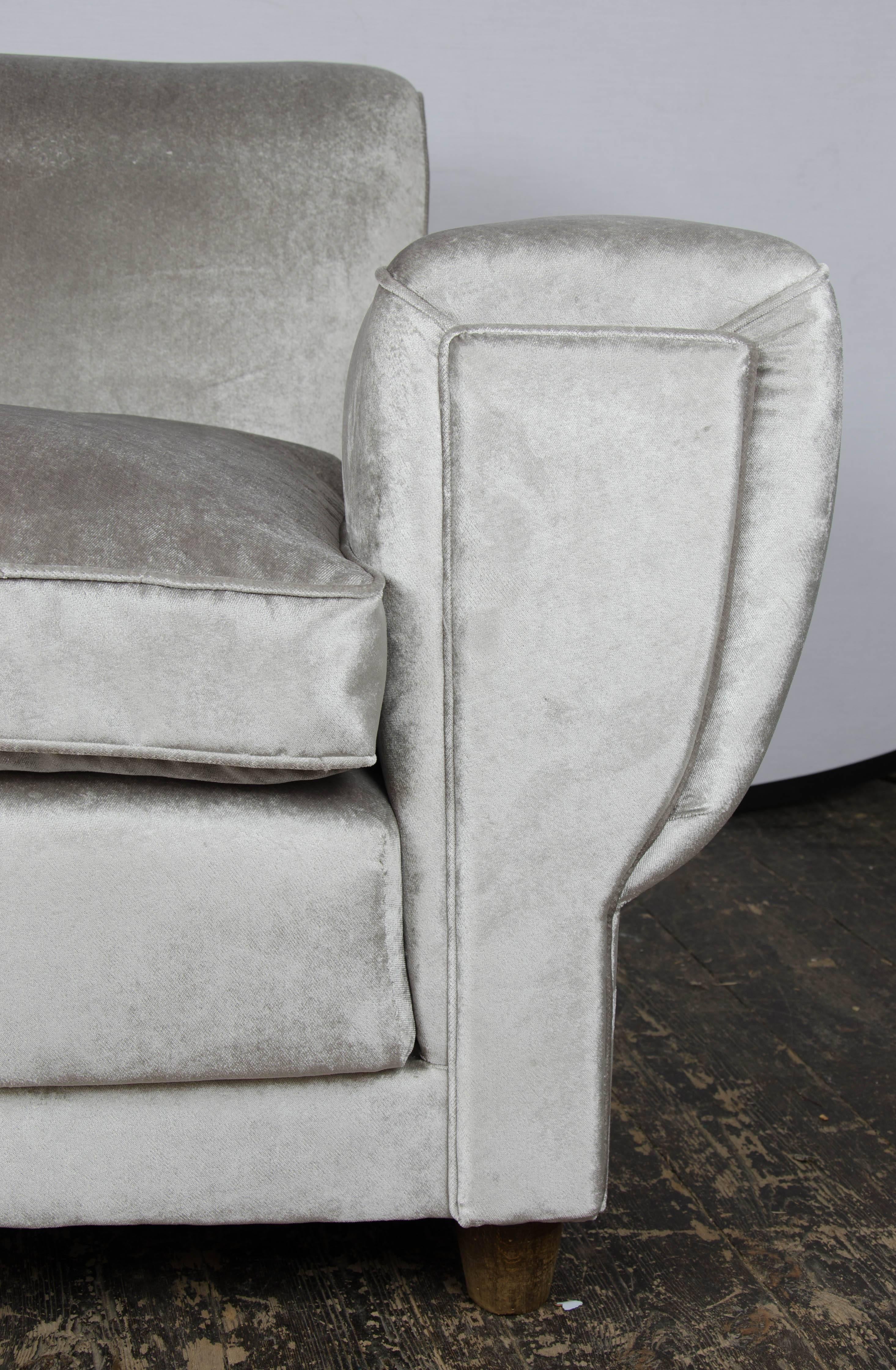 A pair of Art Deco style armchairs re-upholstered in silver velvet with round feet,
Italian, 1940s.