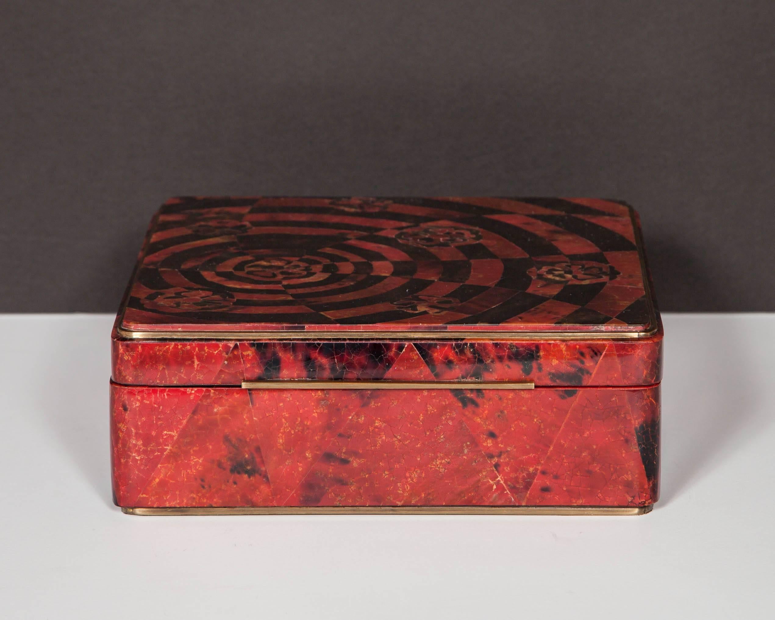 Outstanding large square decorative box comprised of exotic lacquered pen shell. Dyed in hues of ruby red and black, the box features a series of mosaic patterns and a geometric inlay top. All handcrafted and fitted with bronze hardware and hinges.
