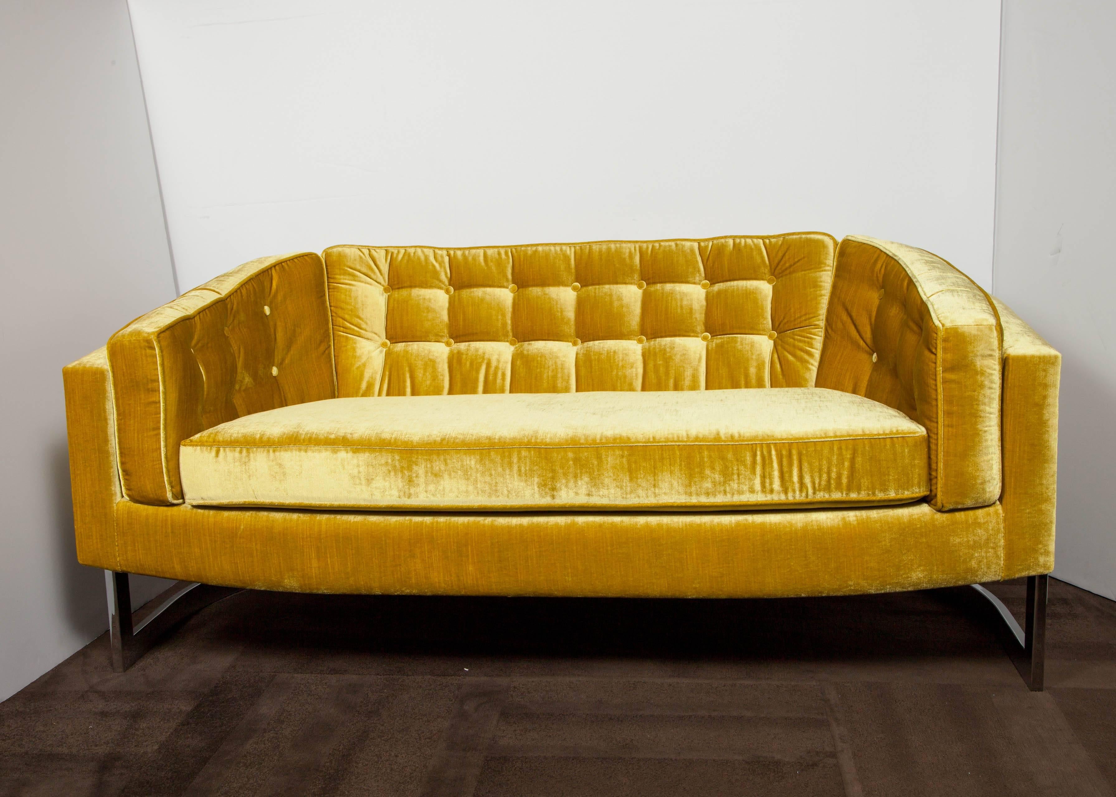 Luxurious loveseat with a streamline cantilevered frame in polished chrome. Ultra chic design with barrel form exemplifying the best of American Mid-Century design. Newly reupholstered in a rich citrine velvet with tailored biscuit tufted details