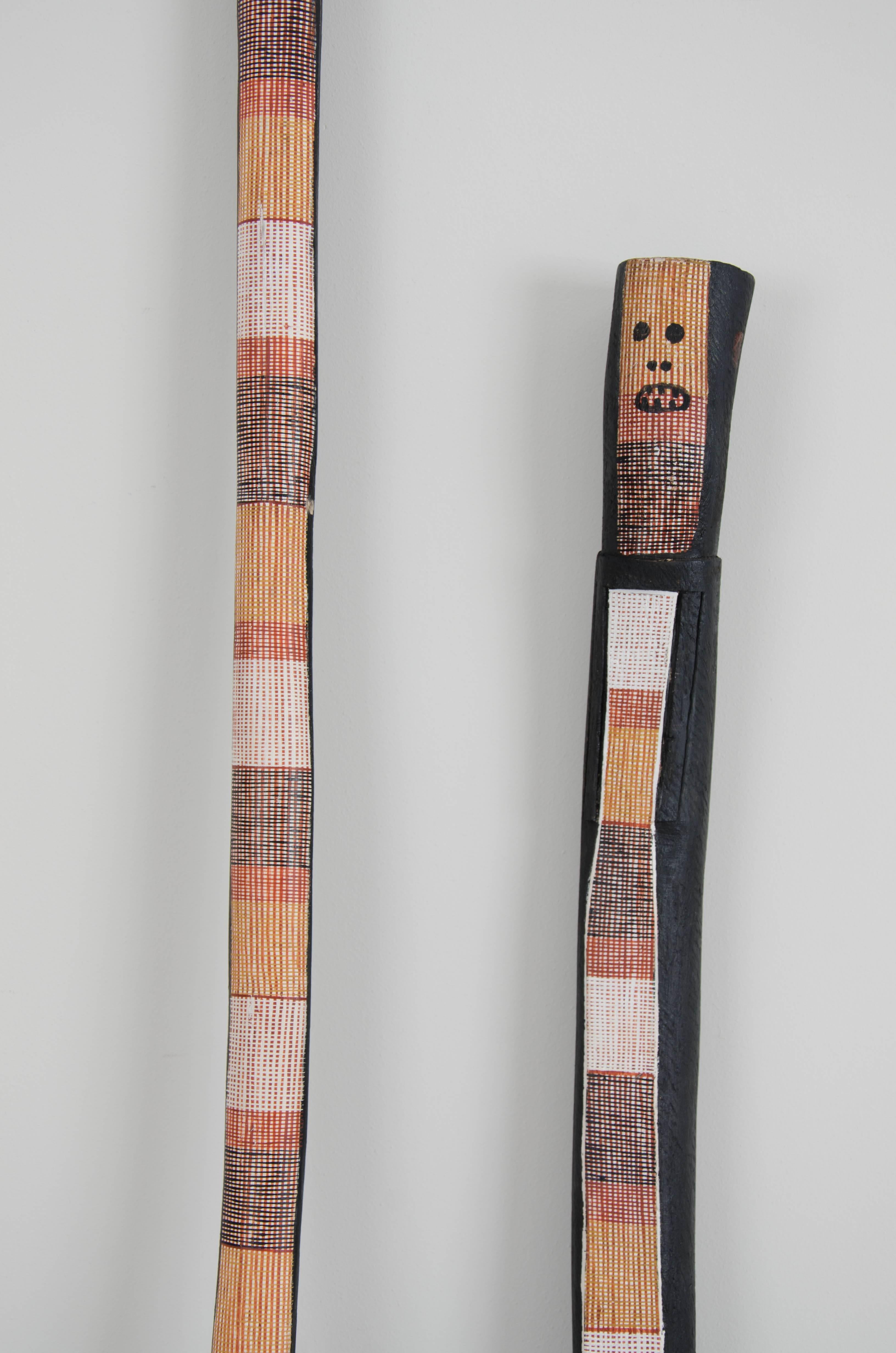 An exquisite pair of finely painted 'mimih spirits' from Australia, which include metal stands.

Aboriginal people in the rocky environments of western and south-western 
Arnhem Land tell of the existence of tall slender spirits which they call