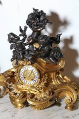 Three-Piece Gilt and Patinated Bronze Clock Garniture Set
