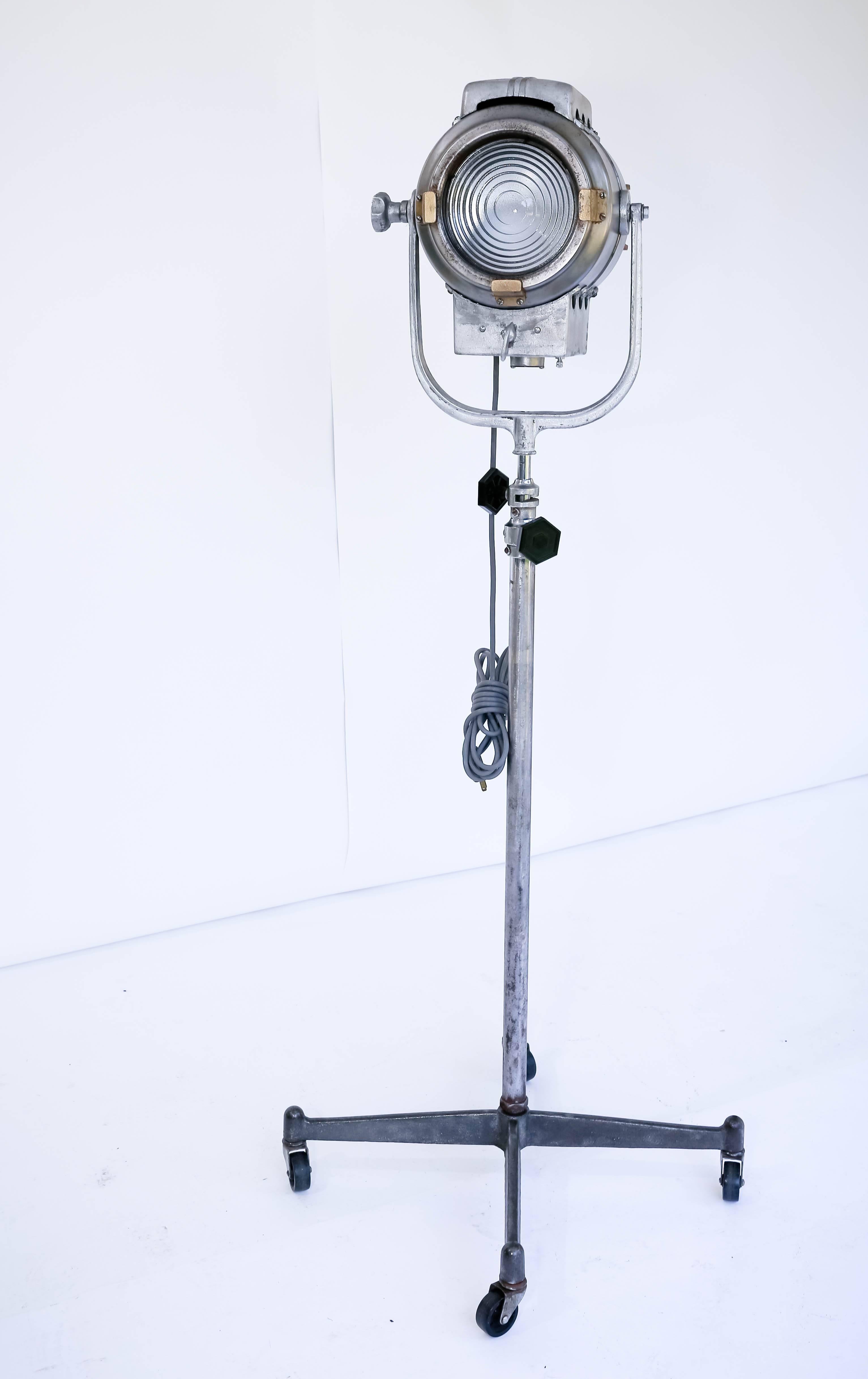 20th century spot light. Adjustable height with stand with castors.