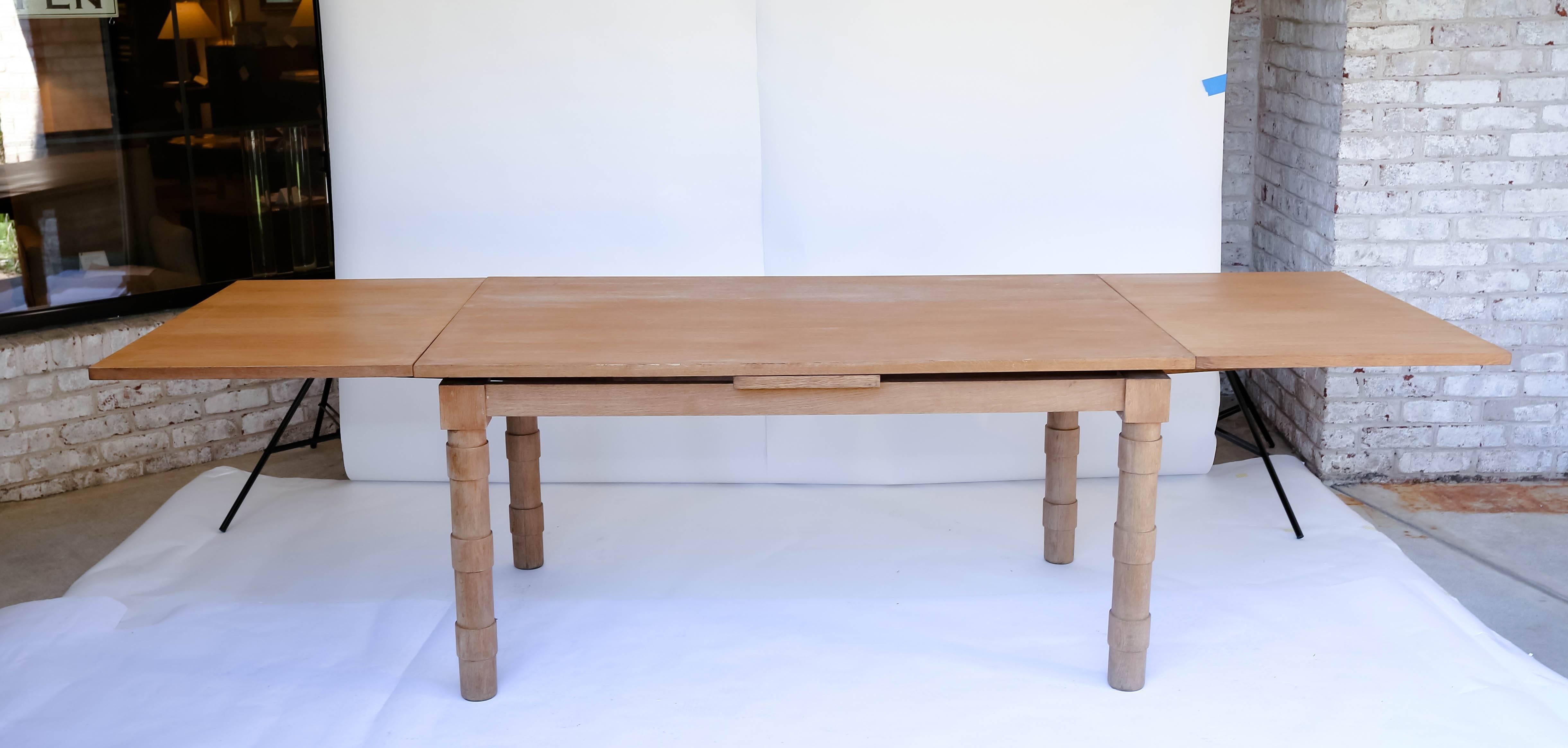 Extendable oak dining table in manner of Guillerme et Chambron. Two leaves: 12