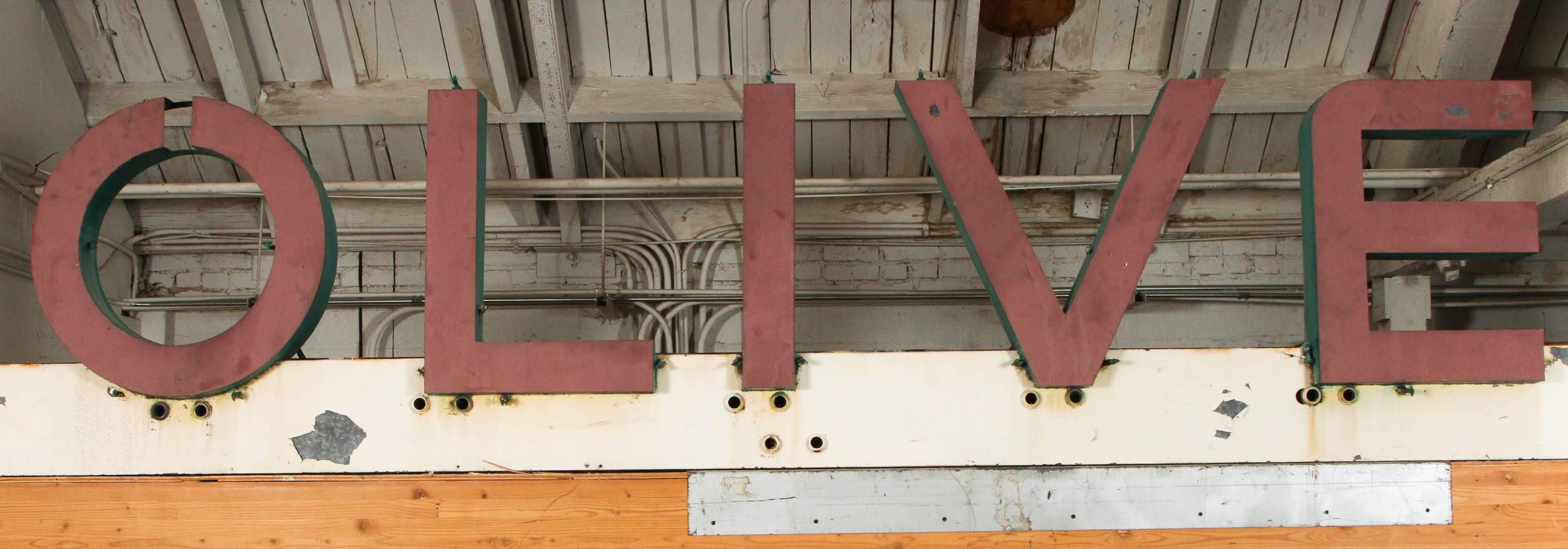 Original Art Deco Metal Sign reads OLIVE, 12 Feet Long For Sale