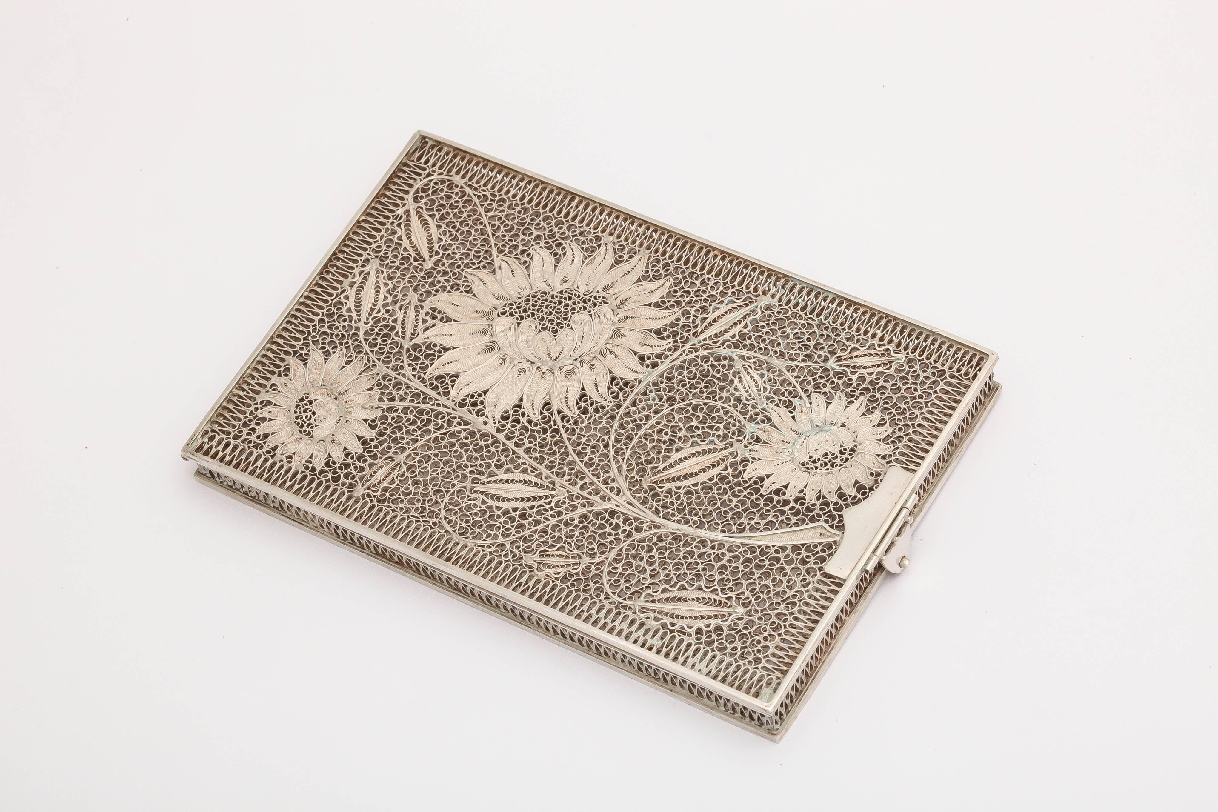 A delicate floral sterling silver card case with clasp.