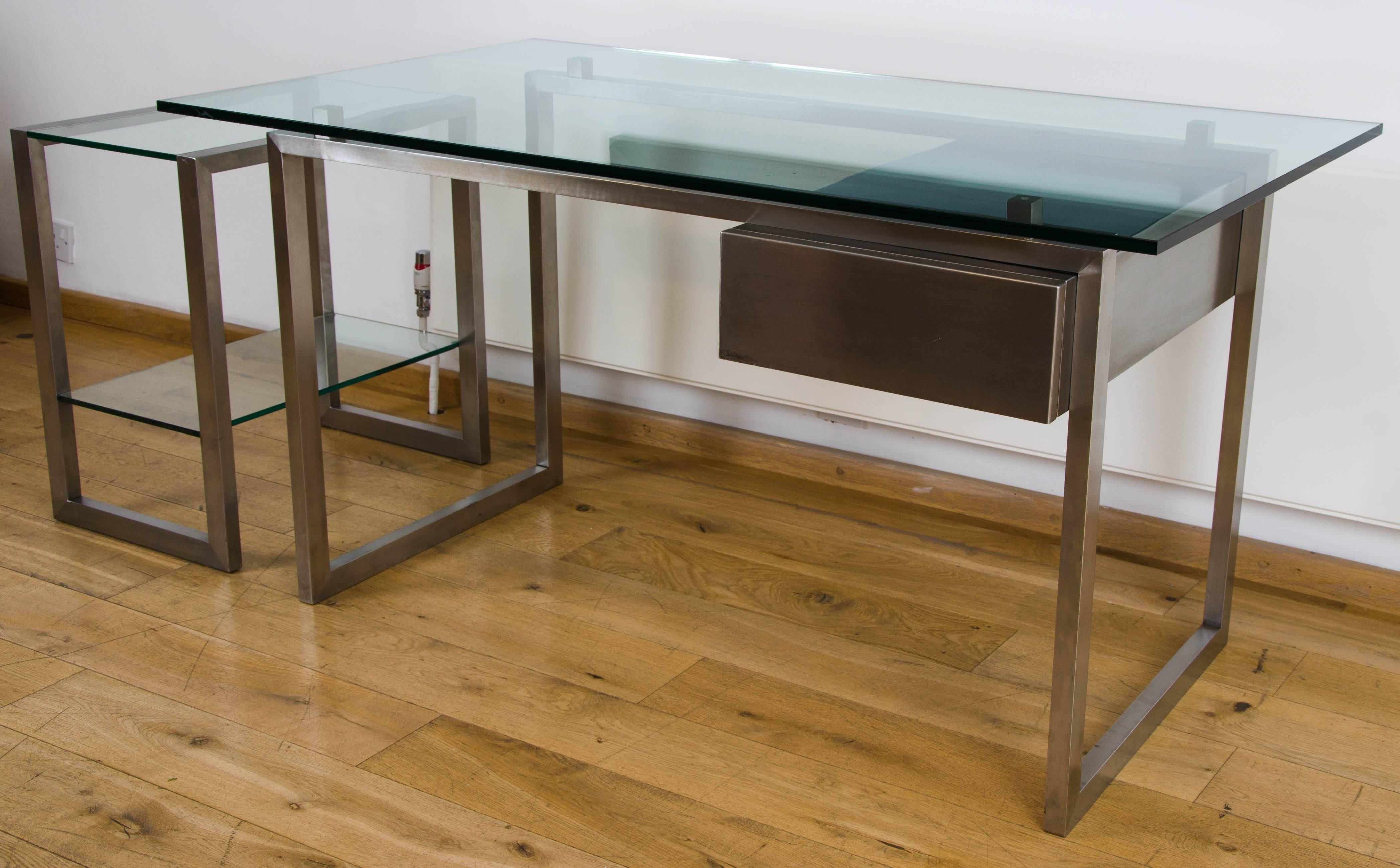 Attributed to Paul Legeard
Stylish 1970s brushed stainless steel desk with single right hand drawer,
with separate companion shelving unit. Measures: H 63.5cm x W 40cm x D 60cm.