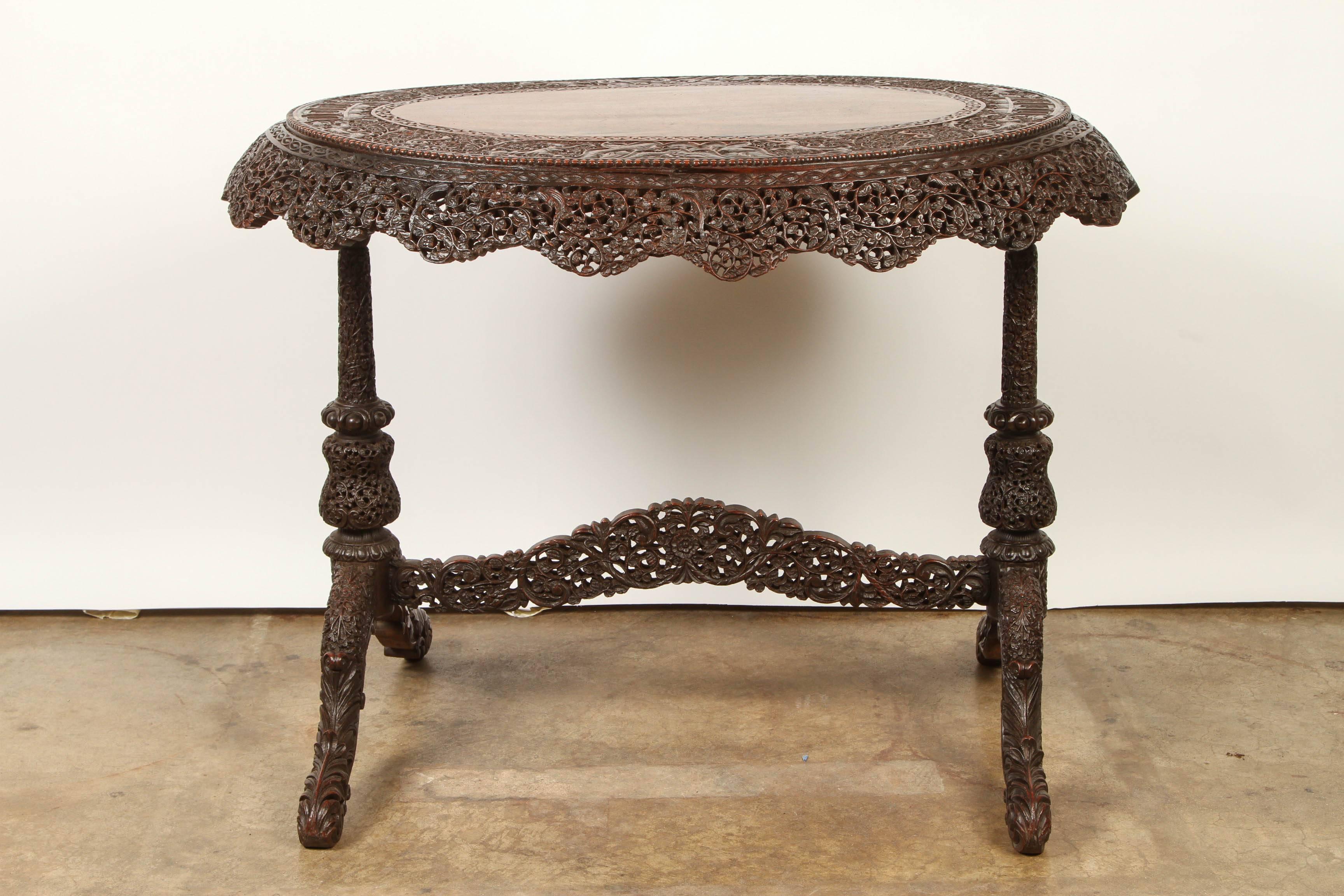 A wonderfully carved and pierced 19th century rosewood Bombay style side table. The center plate is left un-carved to highlight the beautiful grain of the rosewood.