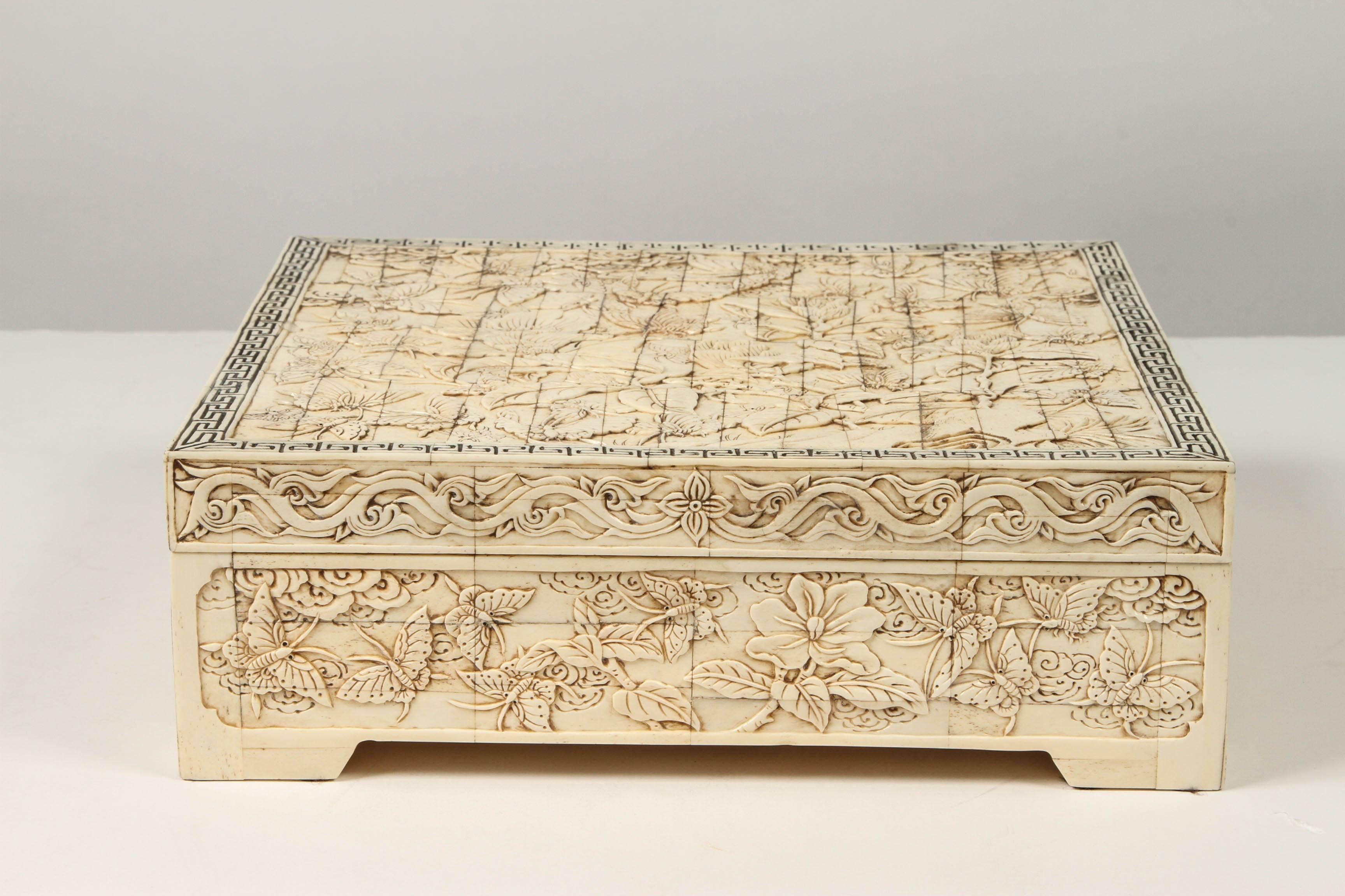 Finely carved square bone box.  Single lid opens to reveal a bone lined interior with a carved interior edge.