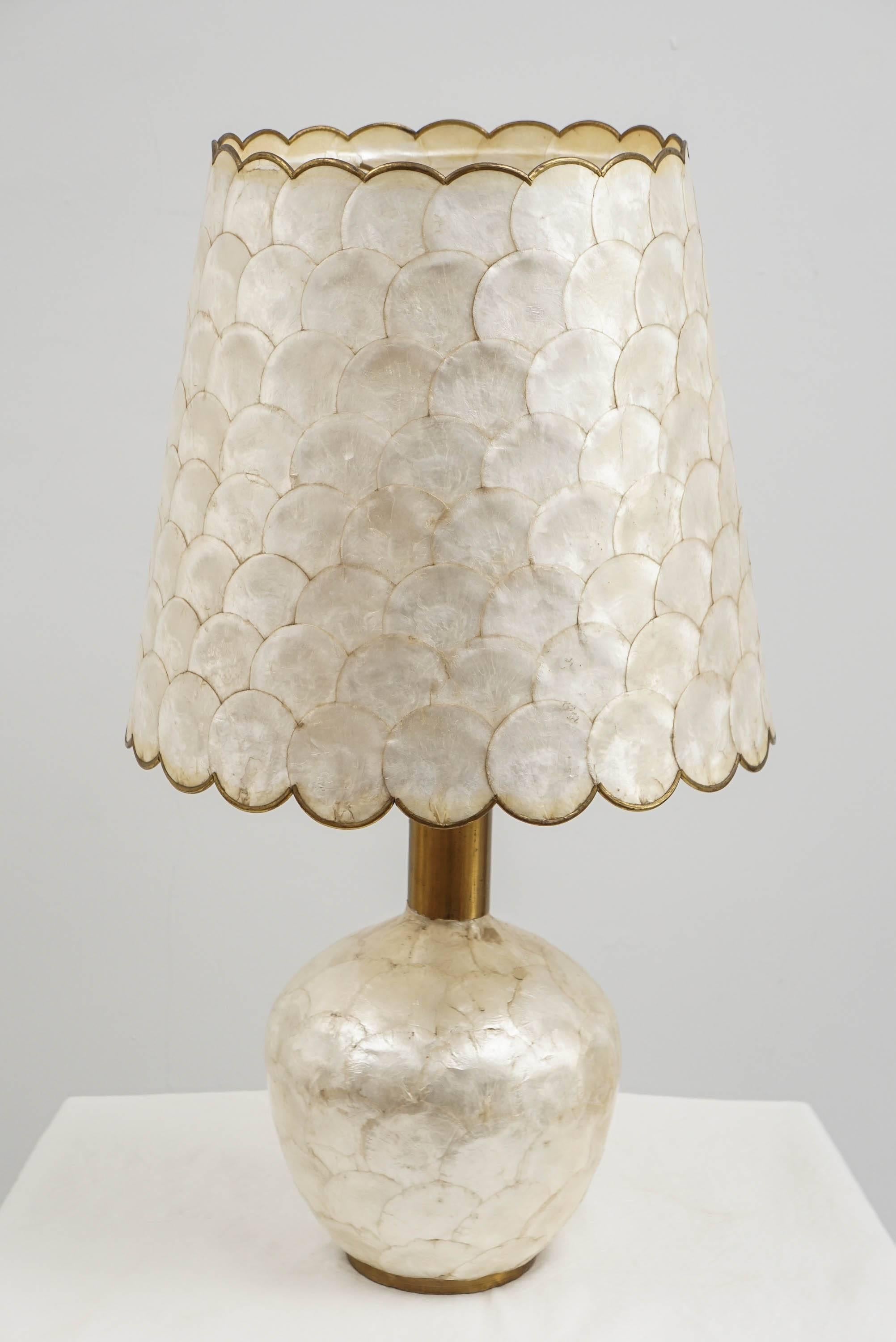 just a lovely 70's glam capiz shell lamp with brass detail.
its a great lamp and in wonderful shape.
i have never seen such a beautiful lamp!
very Karl Springer. no markings. 