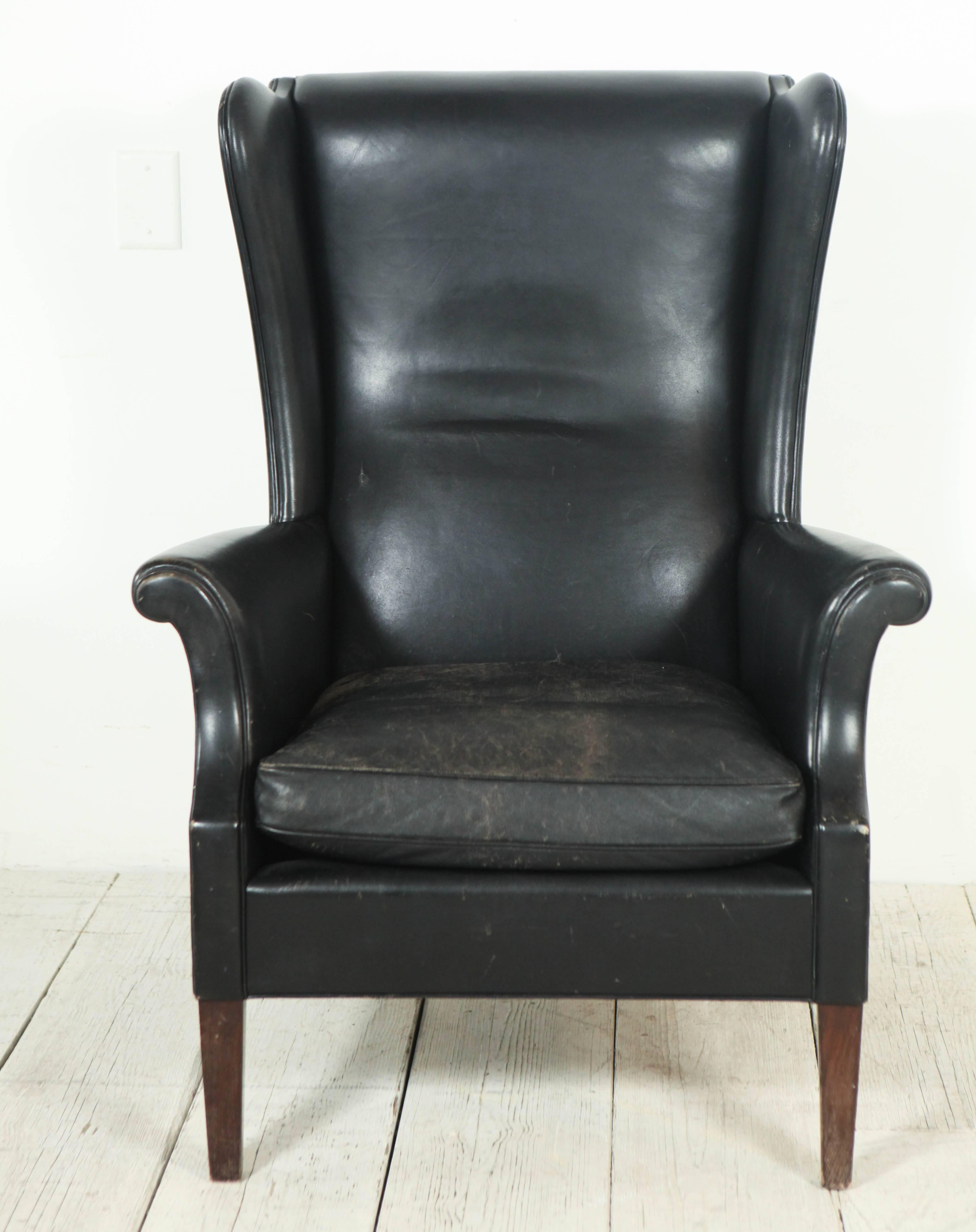 Beautiful tall wingback lounge chair with scrolled arms.