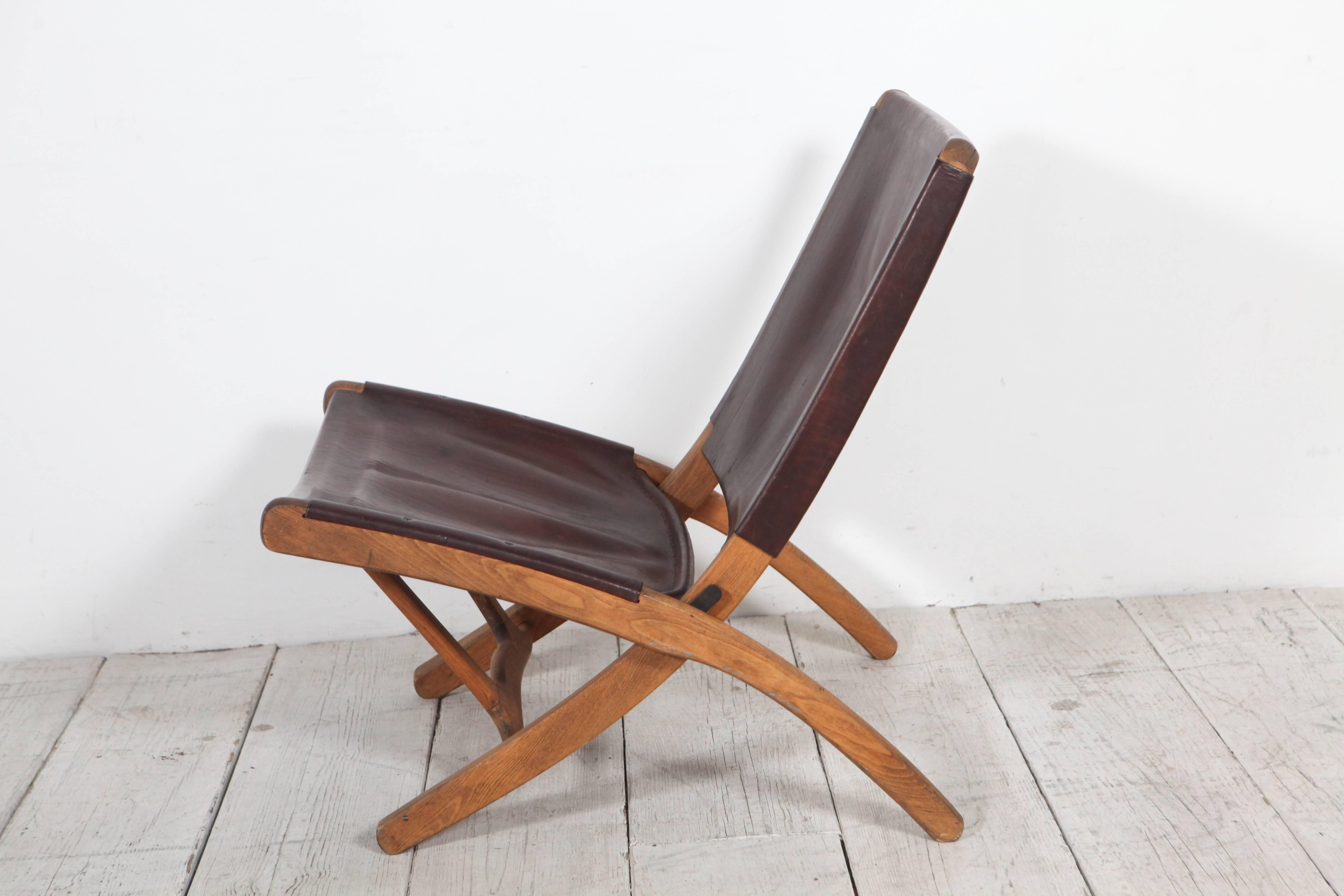 Impressive folding chair in rich leather and collapsible frame.