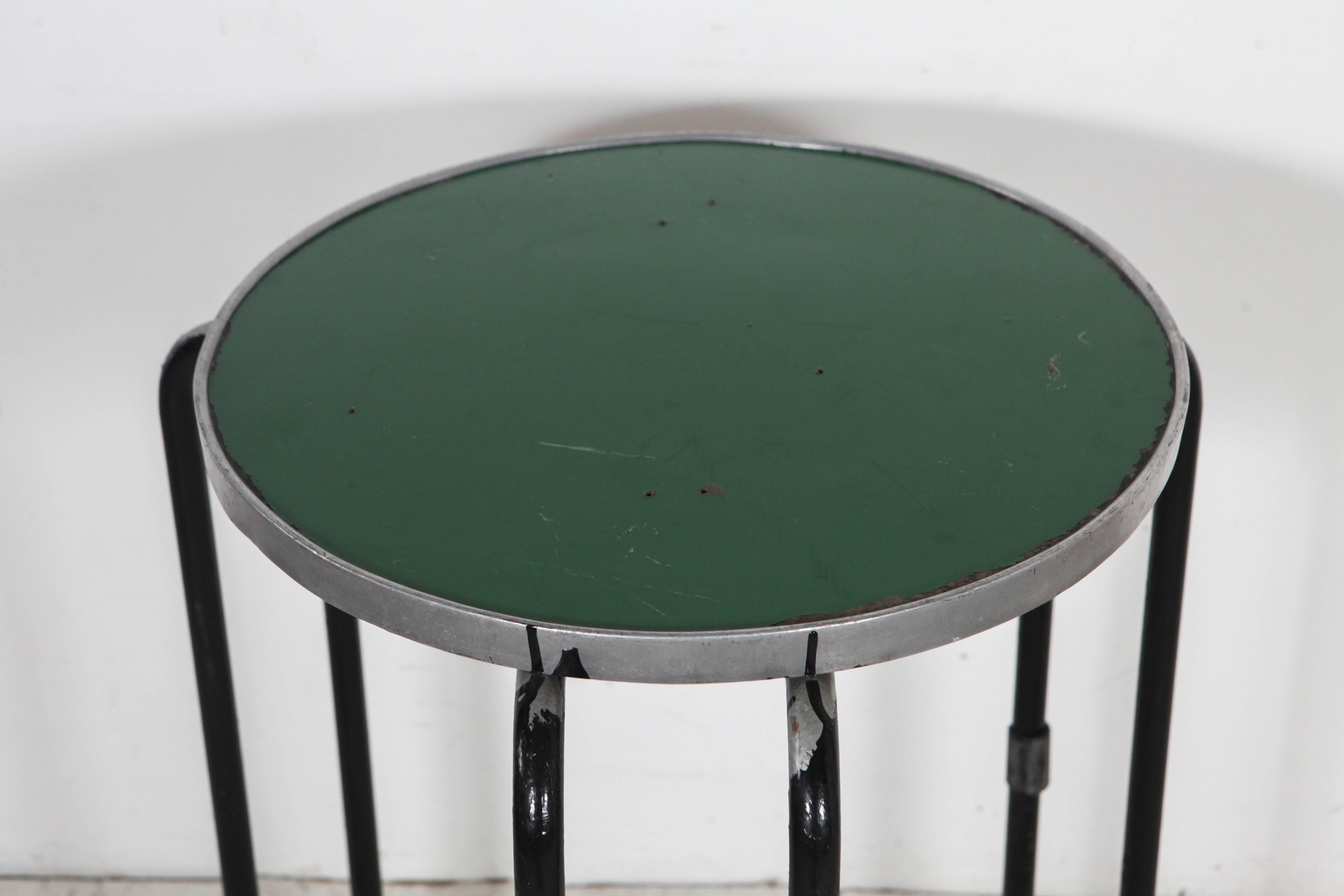 Tall green round side table with excellent black legs.