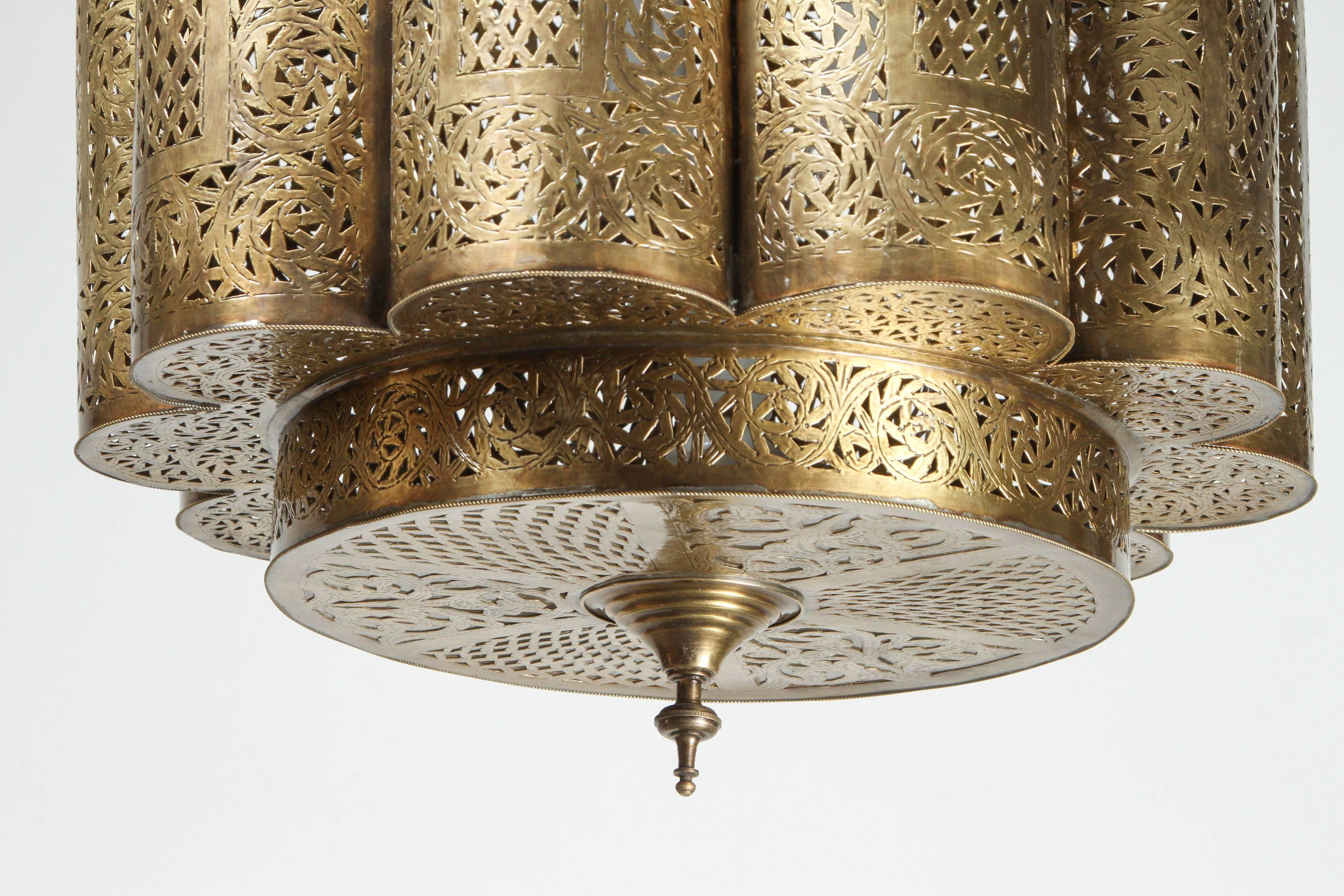 Large pair of pierced brass Moroccan chandelier in the style of Alberto Pinto design.
This Moorish light fixture is delicately hand-crafted, hand hammered and chiseled with fine Moorish filigree designs by skilled Moroccan artisans.
A pair is