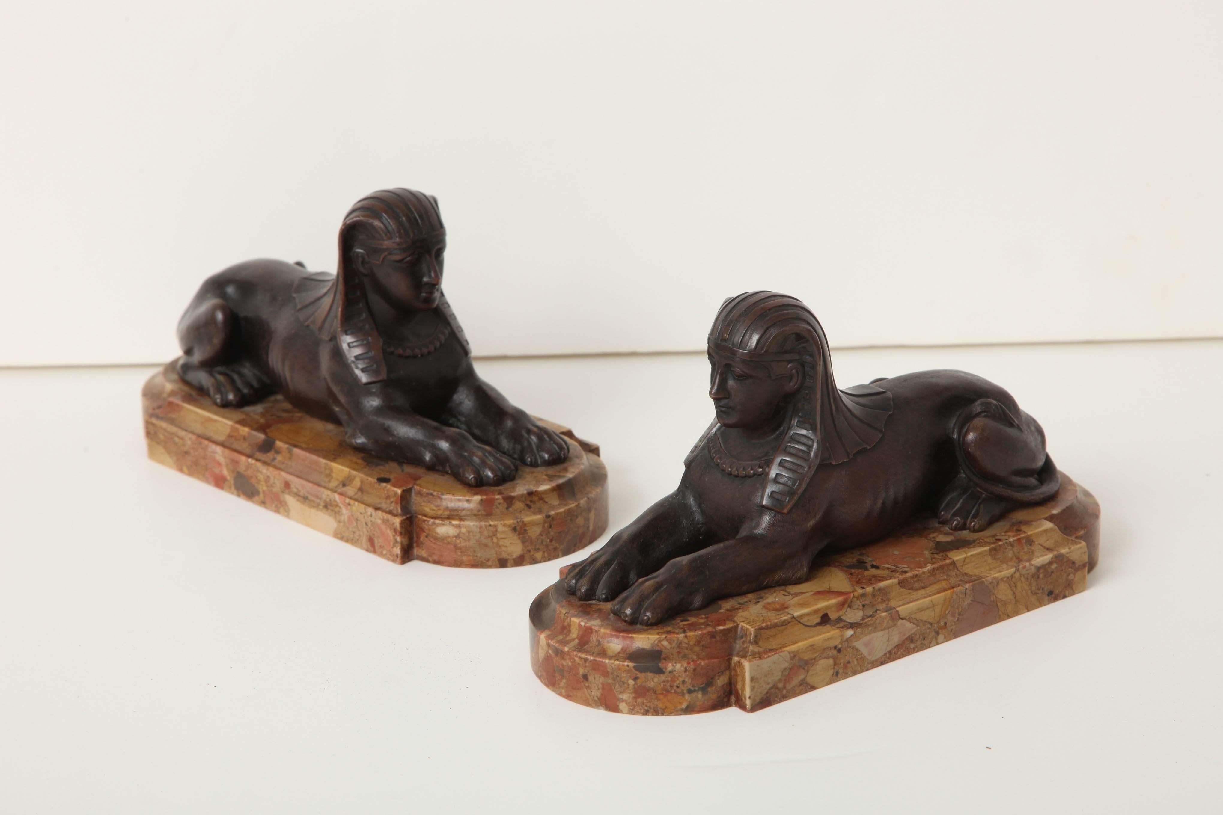 A pair of early 19th century English bronze sphinxes on later breche d’Alep shaped bases
circa 1810