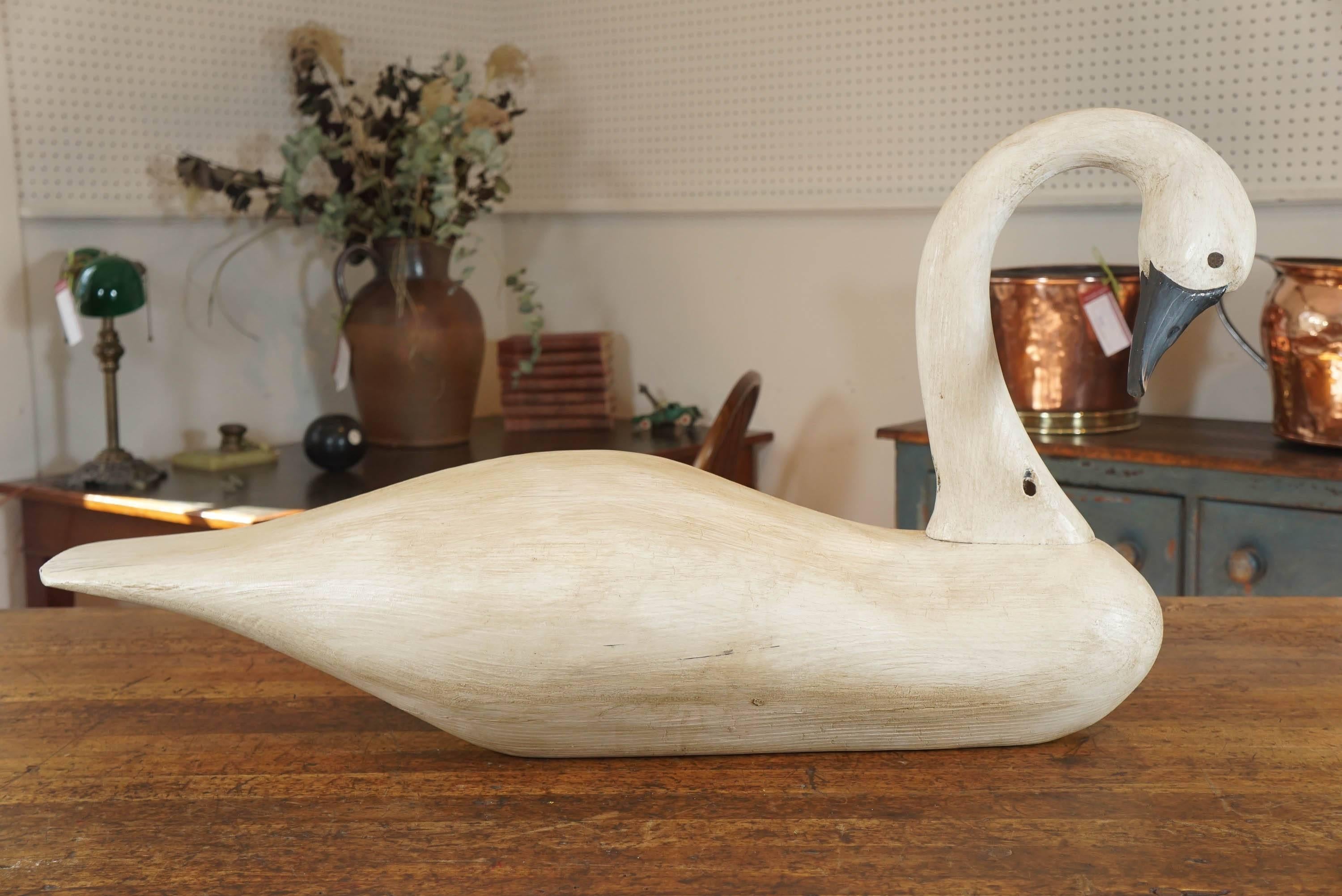 The wood carver of this swan has been making us pieces for many years. It is their swans and eiders that we love the most. Notice the head dipping in one direction the piece is waxed to give it an antique feeling and sits flat on a table, buffet,