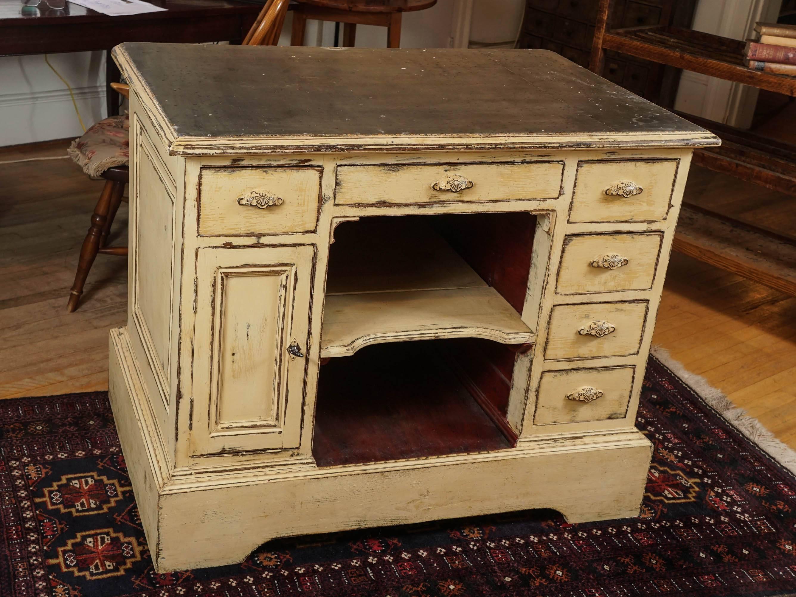 This French zinc top store counter came from a jewelry store. It is a great size for a kitchen island. The store counter side has six drawers and a storage section on the left with a door and original lock and key. There is also a deep storage area