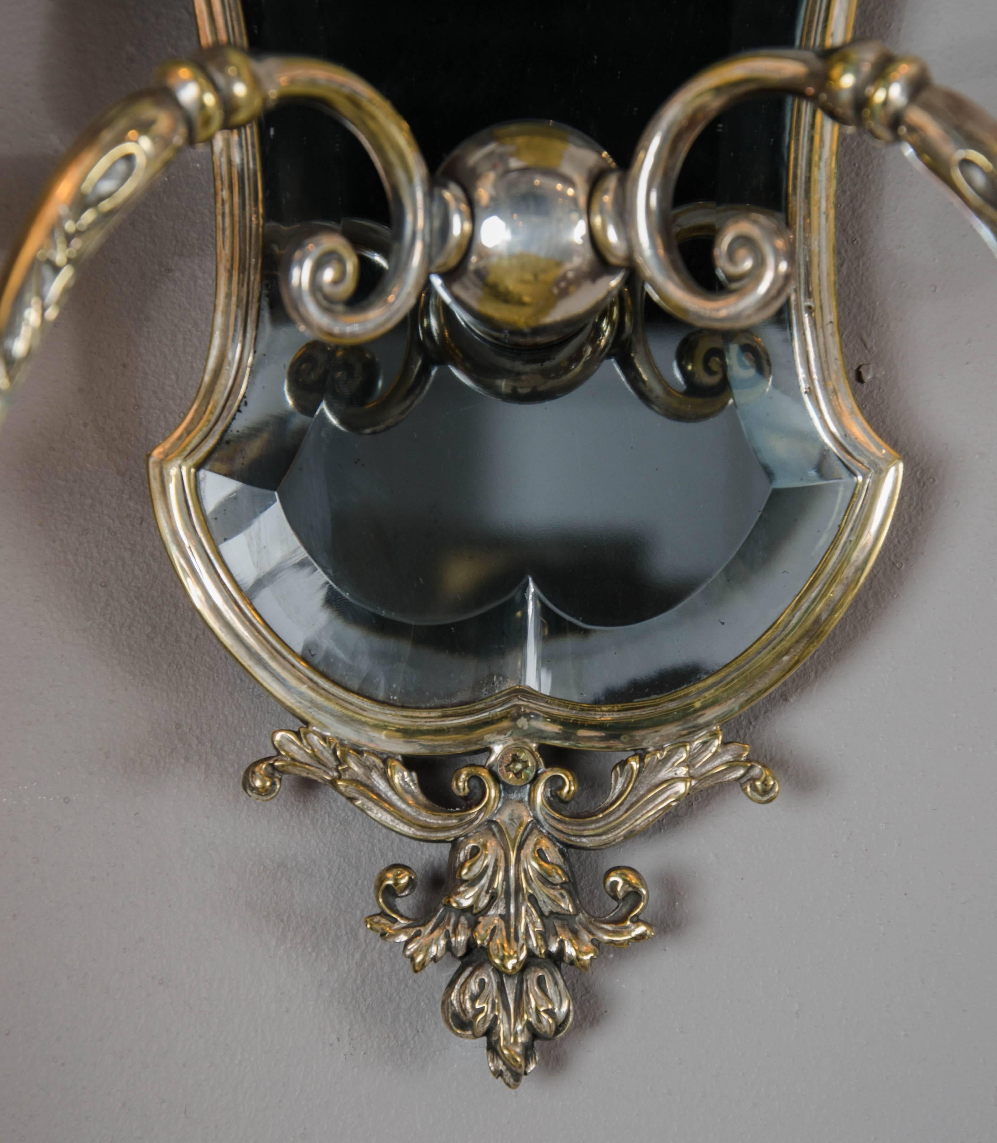 A pair of very smart Edwardian period silver plated two arm wall lights with their original smoked blue glass plates.
With paper shades.