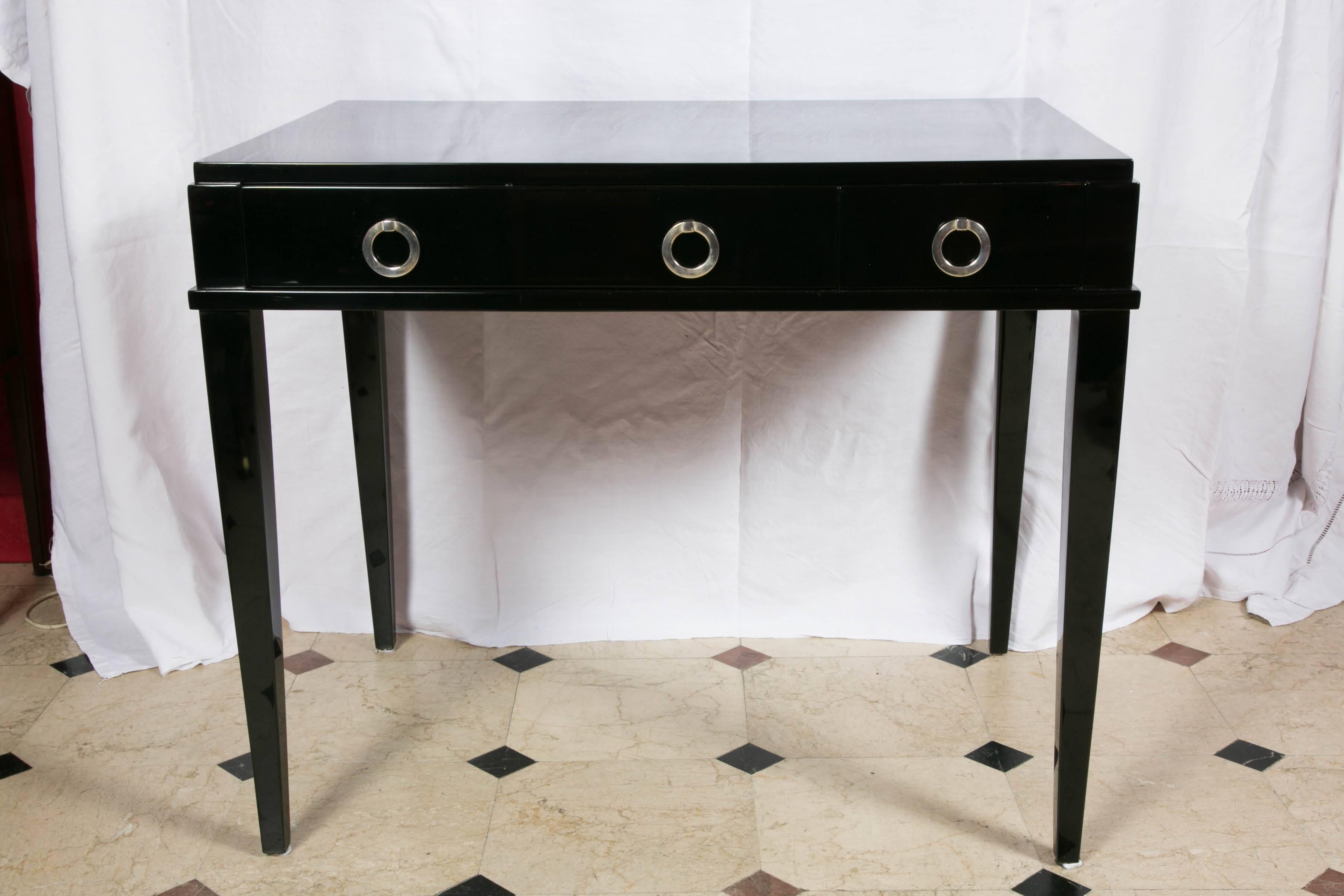 Black lacquer Art Deco desk with two drawers decorated with silvered bronze handles.