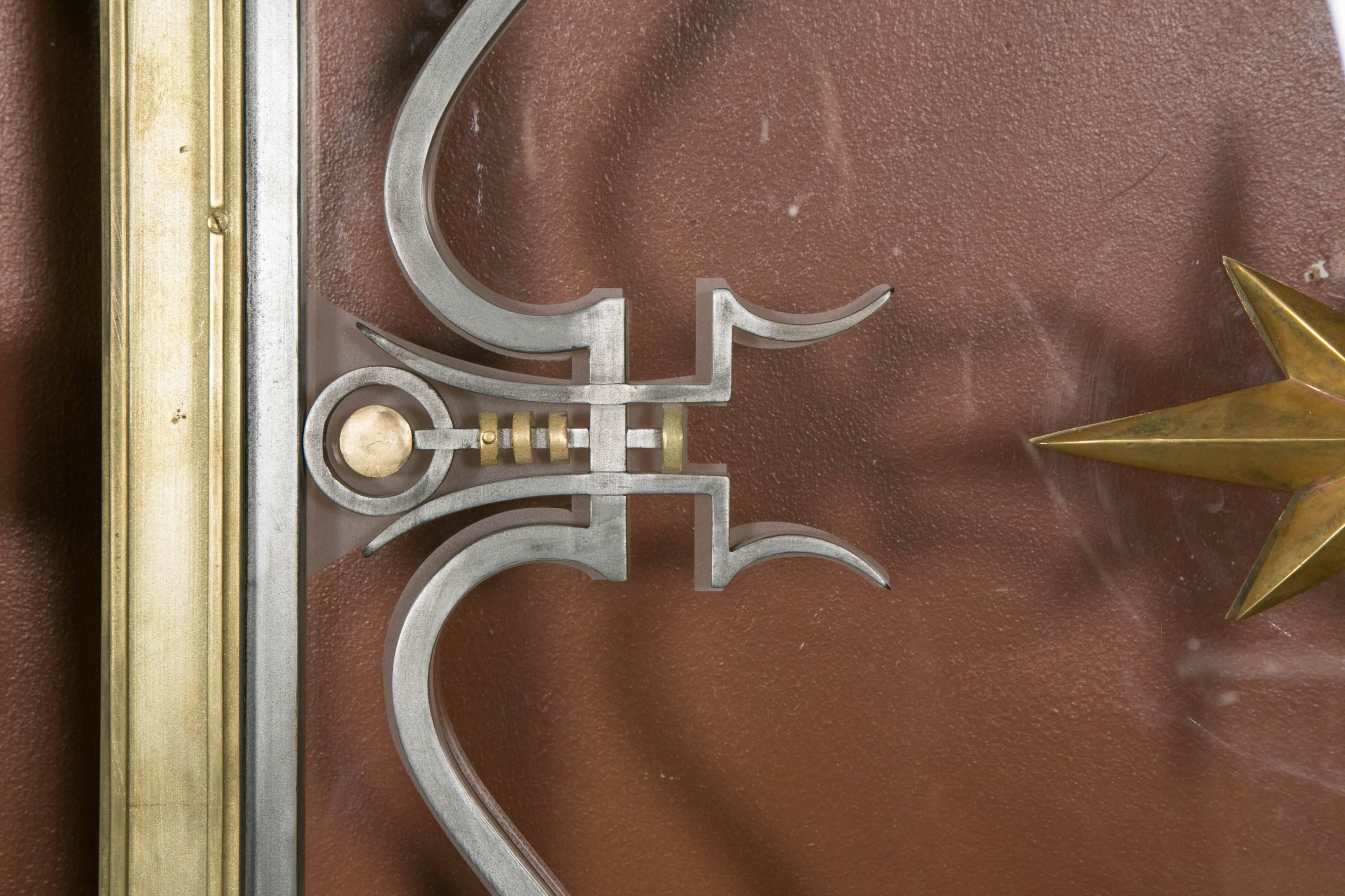 Pair of wrought iron gates with a scrolls and daggers decor and bronze star in the middle. Iron door and back with a sandblasted window glass that replicates the scrolls. The doors are reproduced in the book G. POILLERAT by Y.GASTOU.